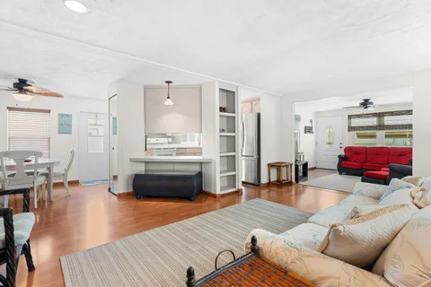 a kitchen with a sink cabinets stainless steel appliances and a window