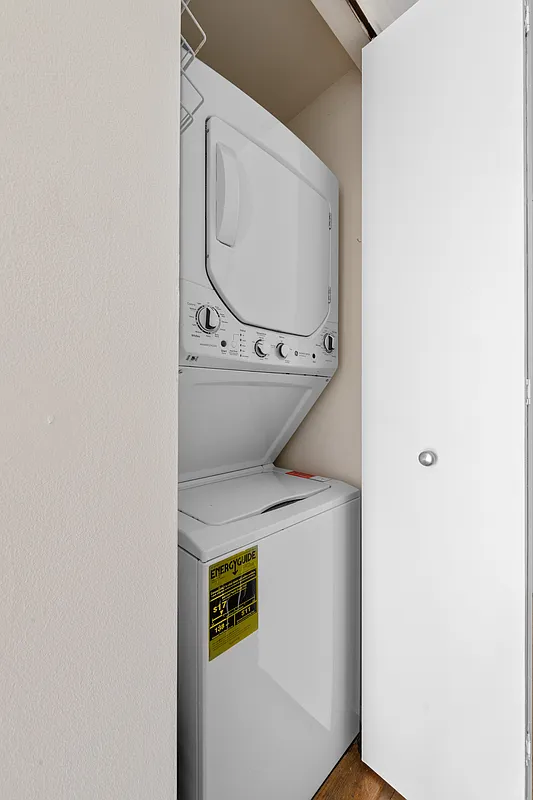 160 West 66th Street, Unit 17E Manhattan, NY 10023 - Photo 4 of 13 a utility room with dryer and washer