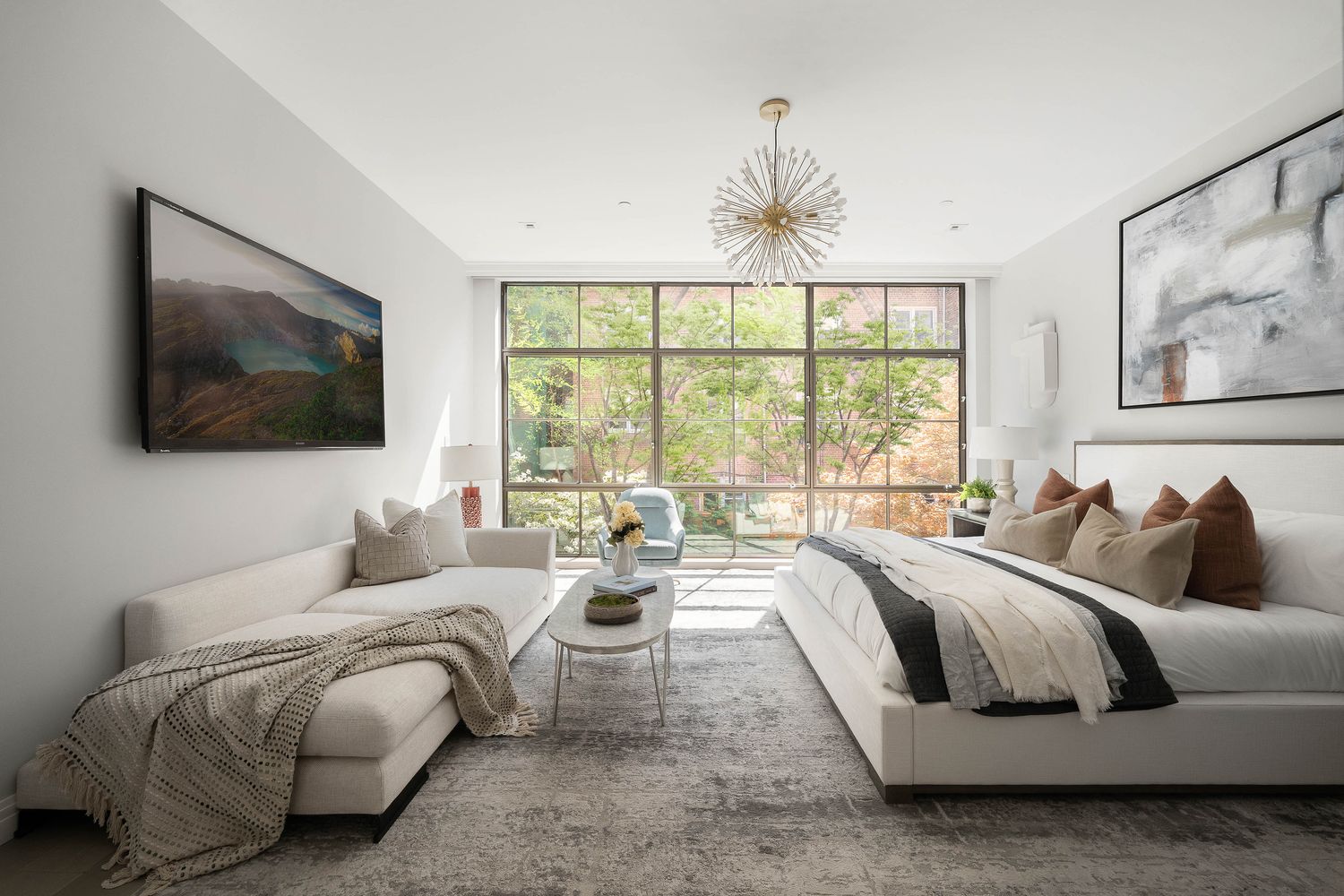 520 East 89th Street Manhattan, NY 10128 - Photo 15 of 40 a living room with a bed furniture and flat screen tv