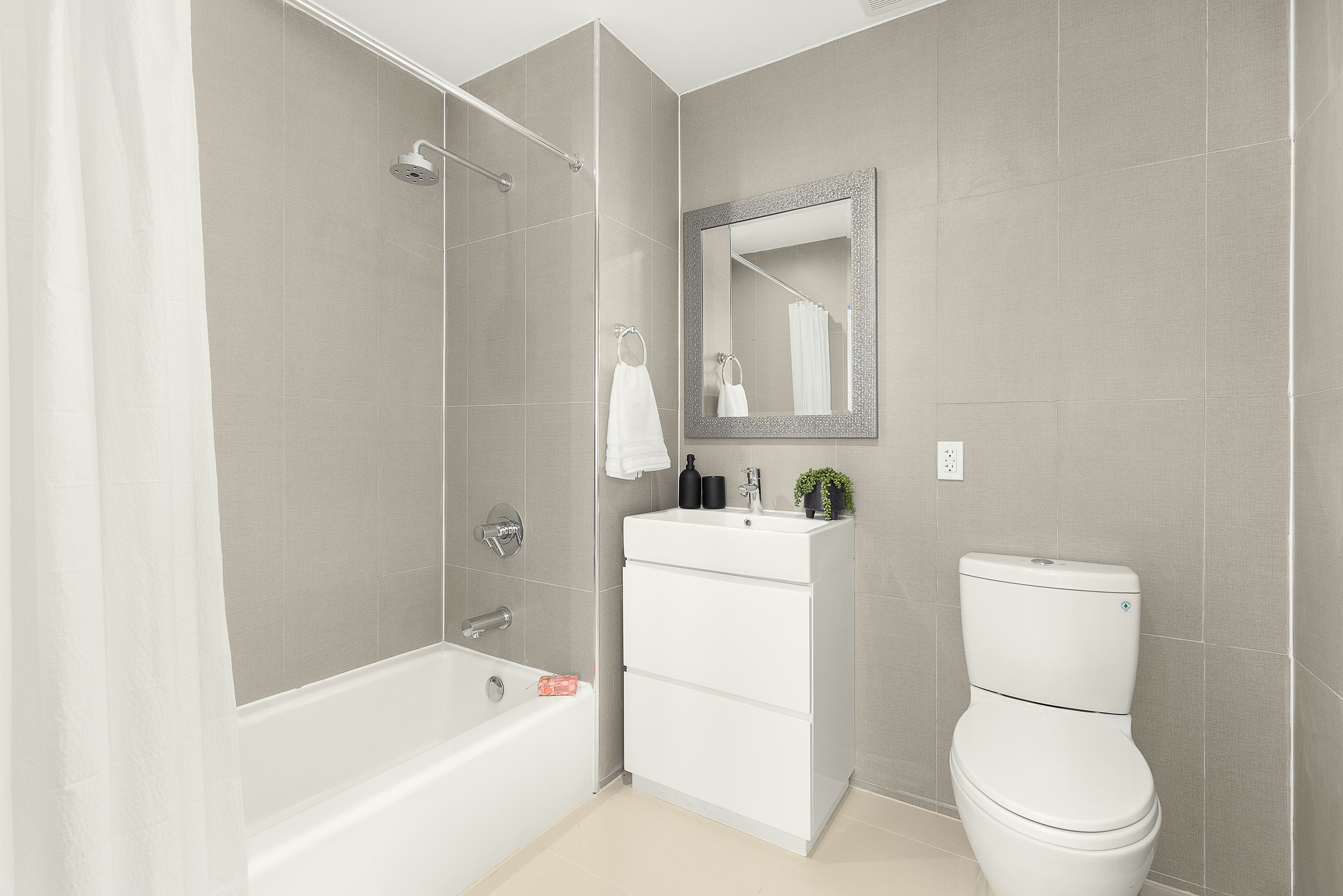 109-09 15th Avenue, Unit PHS611 Queens, NY 11356 - Photo 5 of 11 a bathroom with a toilet and a bathtub