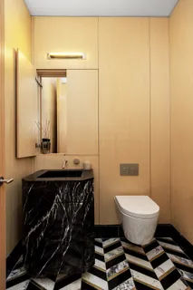 a bathroom with a sink a toilet and mirror