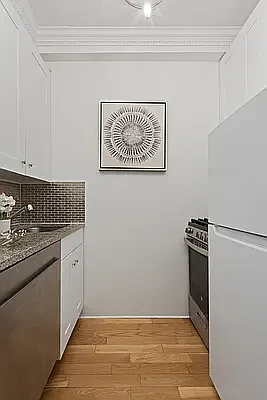 405 West 23rd Street, Unit 10D Manhattan, NY 10011 - Photo 3 of 9 a view of a kitchen with electric appliances