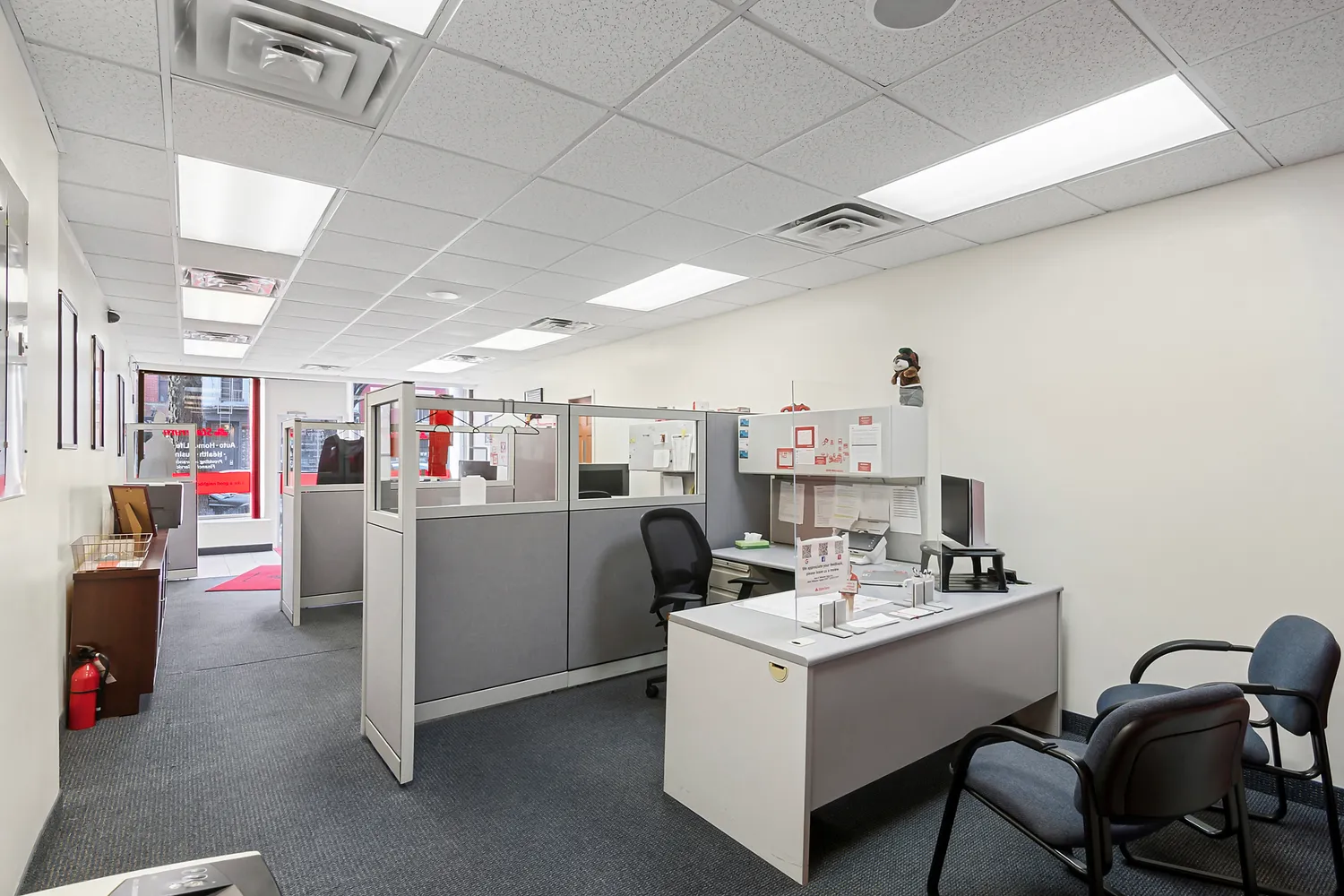 a living room with furniture and a refrigerator