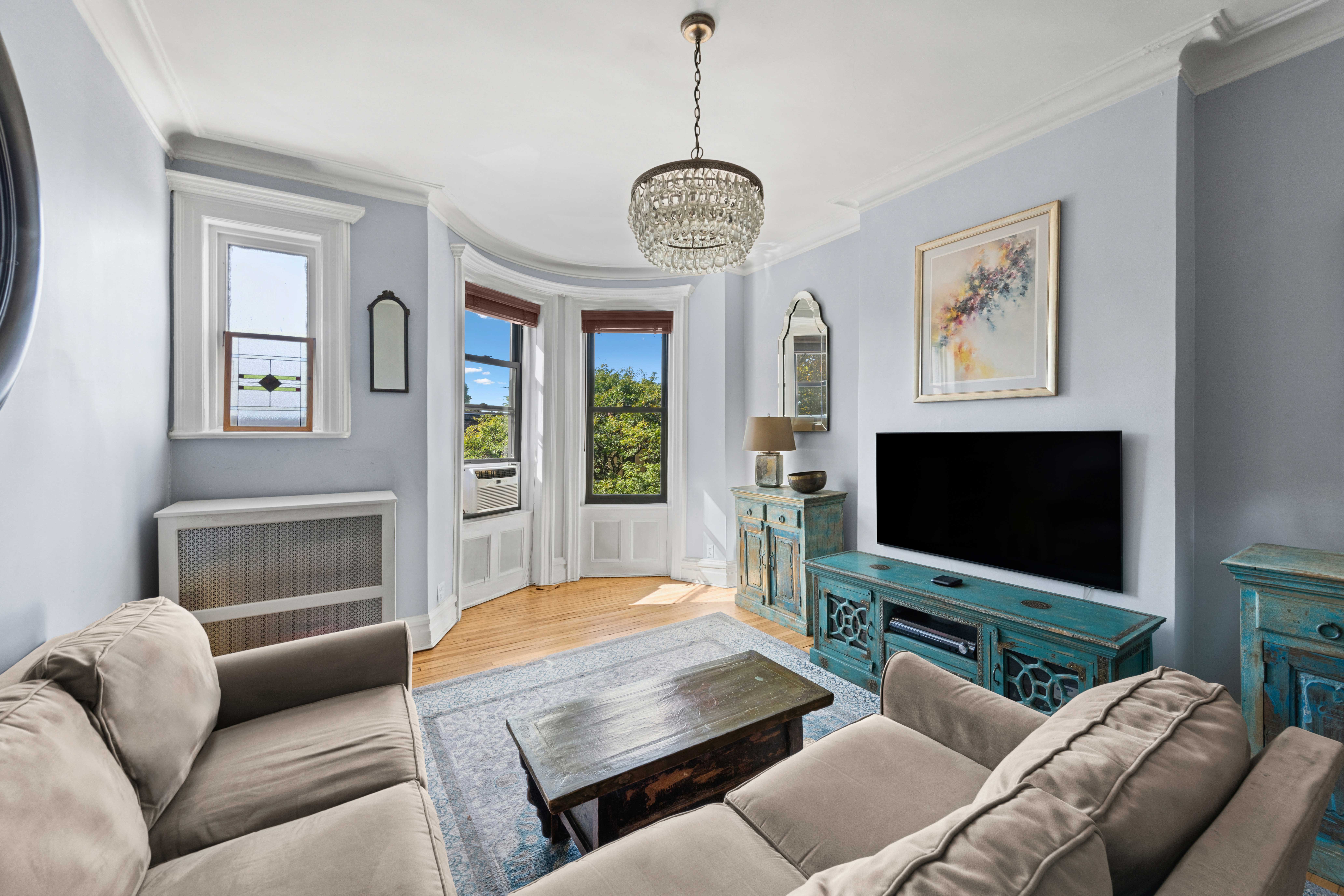 705 Carroll Street, Unit 4L Brooklyn, NY 11215 - Photo 4 of 15 a living room with furniture a ceiling fan and a flat screen tv
