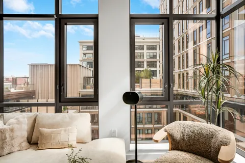 a living room with furniture and a floor to ceiling window