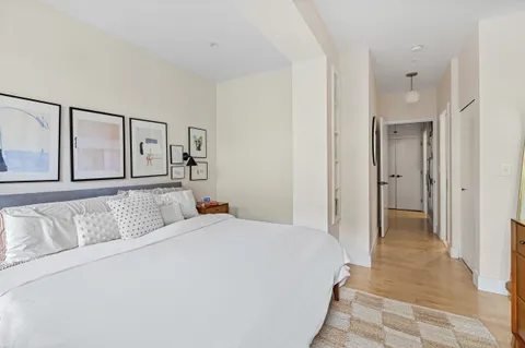 a bedroom with a large bed and a chandelier