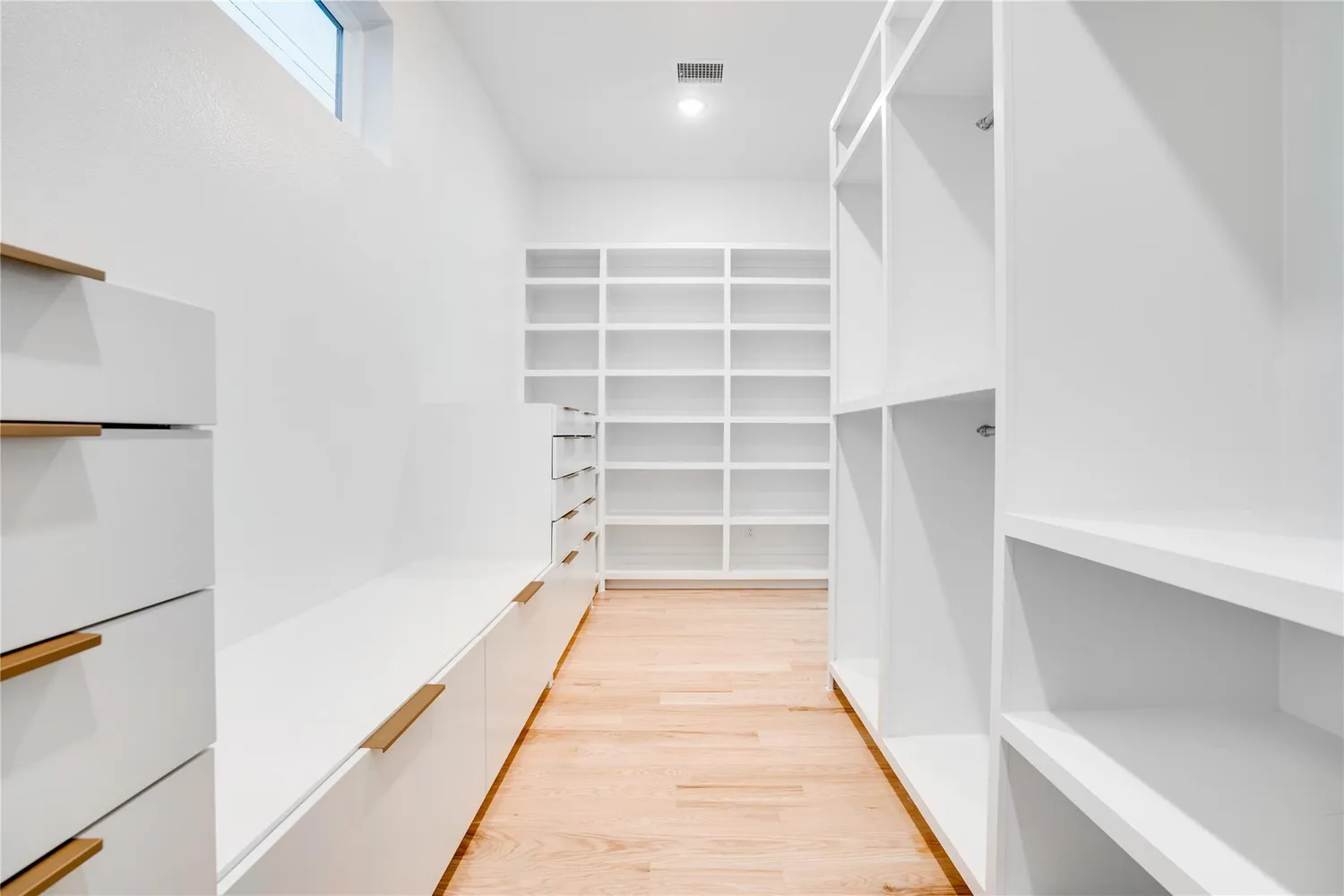 a hallway with closet and wooden floor