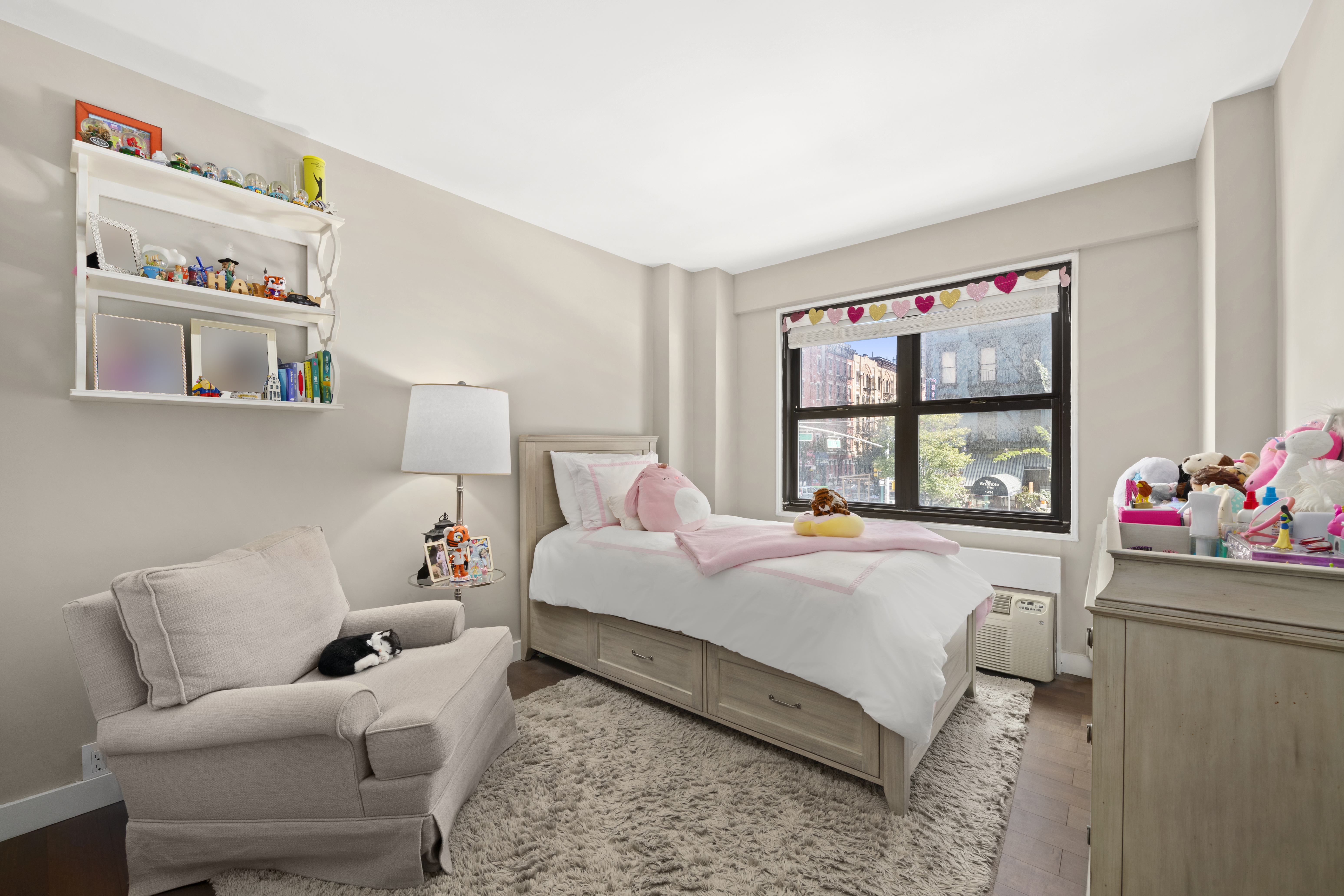 240 East 76th Street, Unit 2E Manhattan, NY 10021 - Photo 6 of 11 a bedroom with a bed and a large window