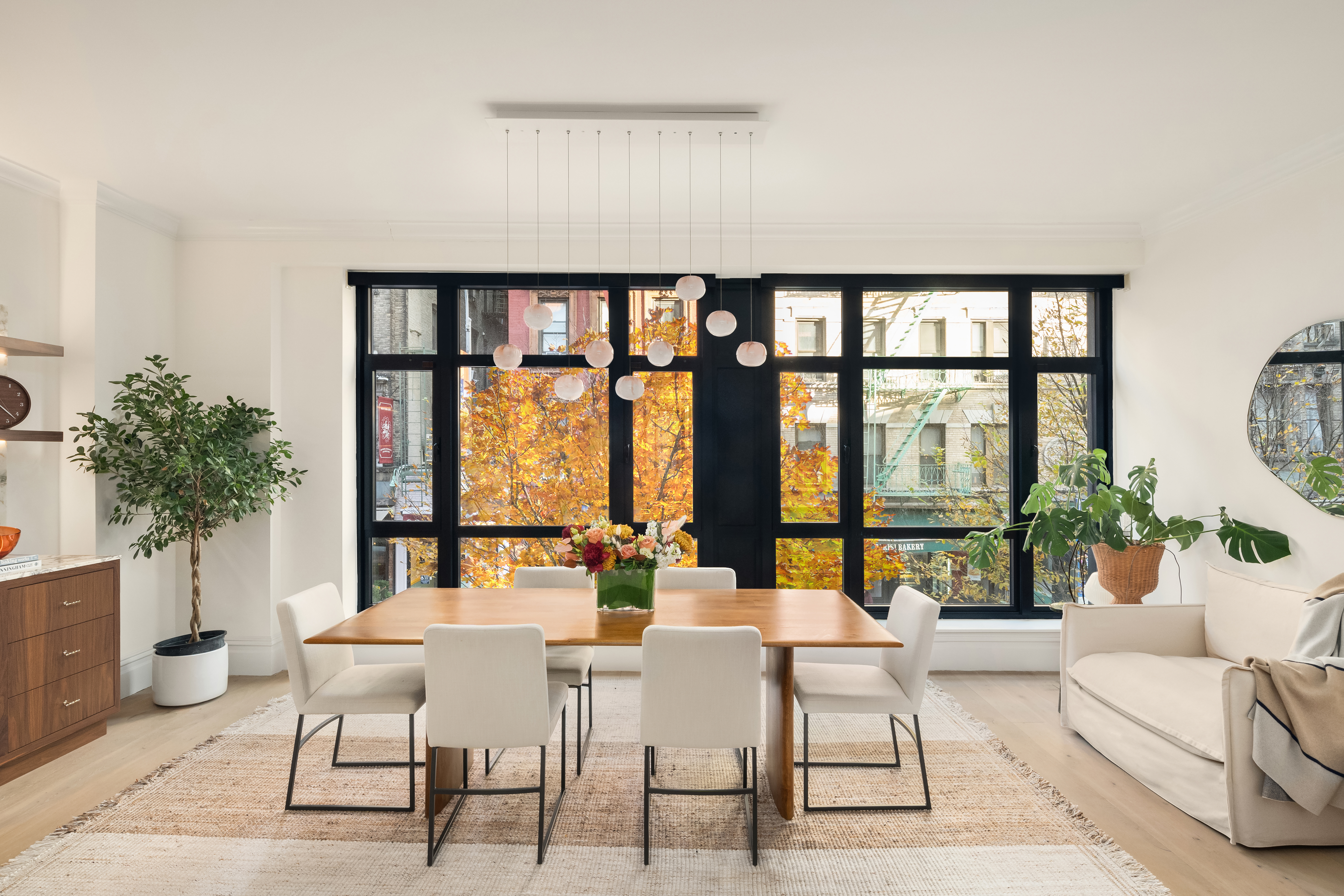 199 Mott Street, Unit 2 Manhattan, NY 10012 - Photo 5 of 14 a living room with furniture and a large window