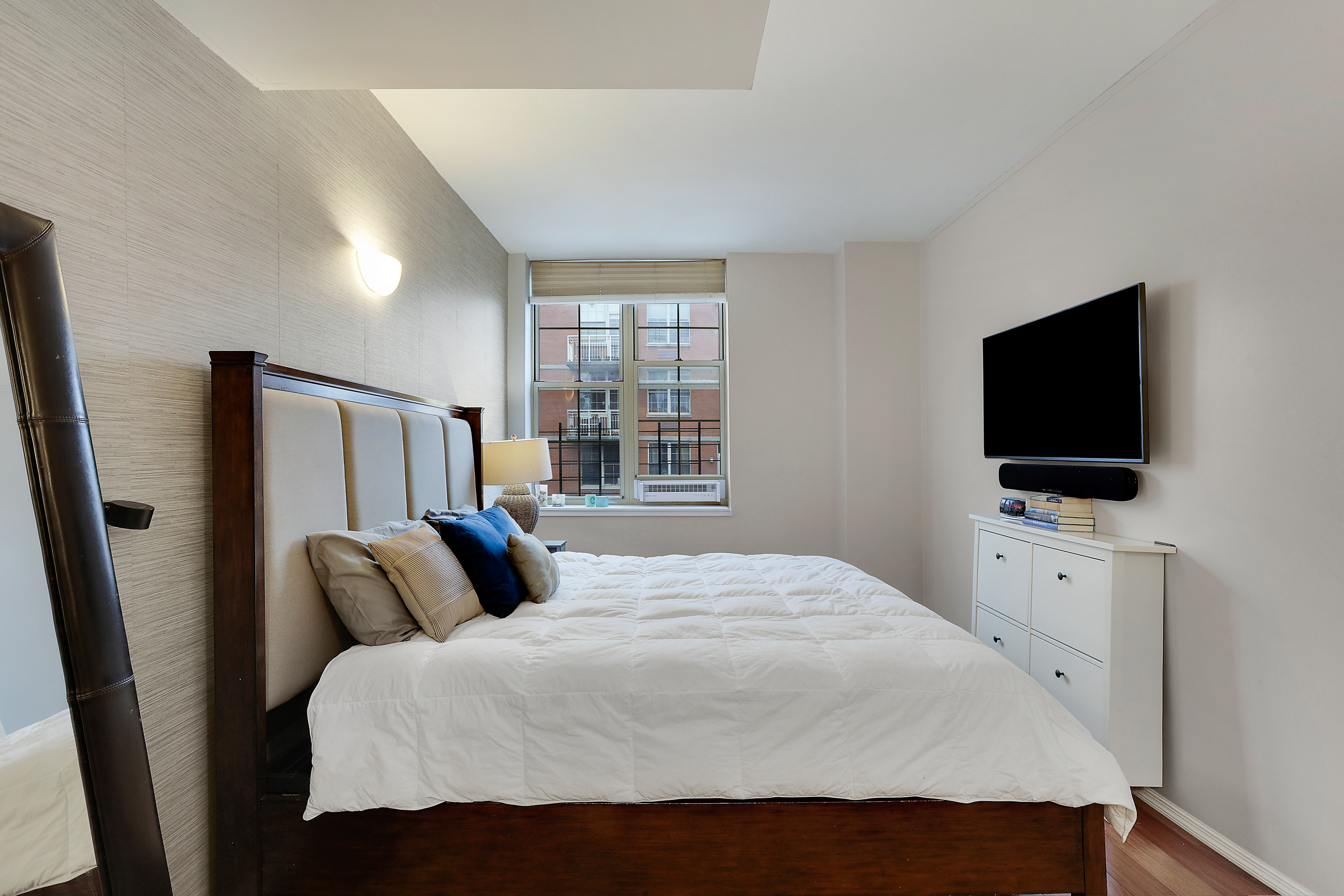 313 West 119th Street, Unit PHE Manhattan, NY 10027 - Photo 7 of 19 a bedroom with a bed and a flat screen tv