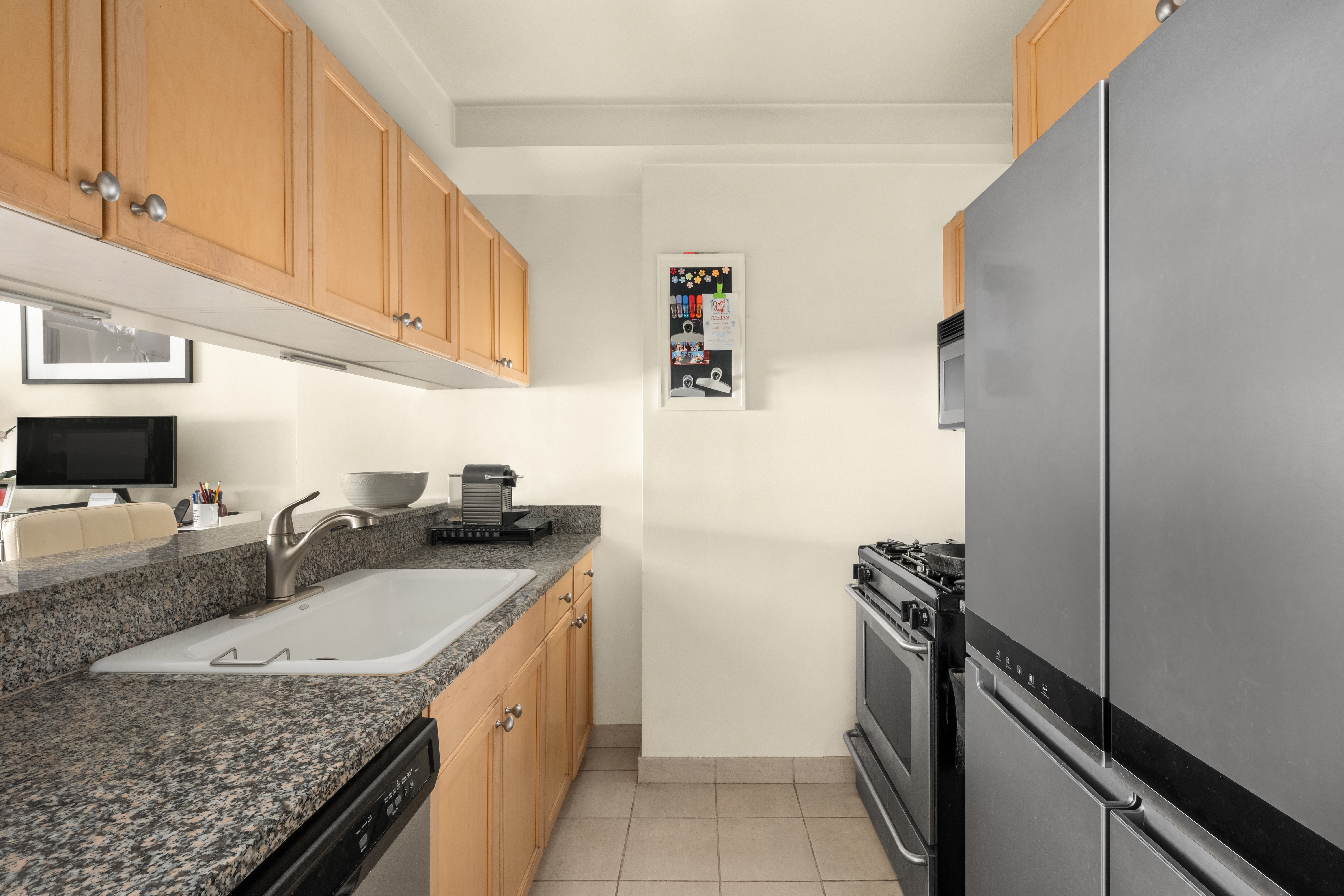 1760 2nd Avenue, Unit 5E Manhattan, NY 10128 - Photo 3 of 6 a kitchen with stainless steel appliances granite countertop a sink stove and refrigerator