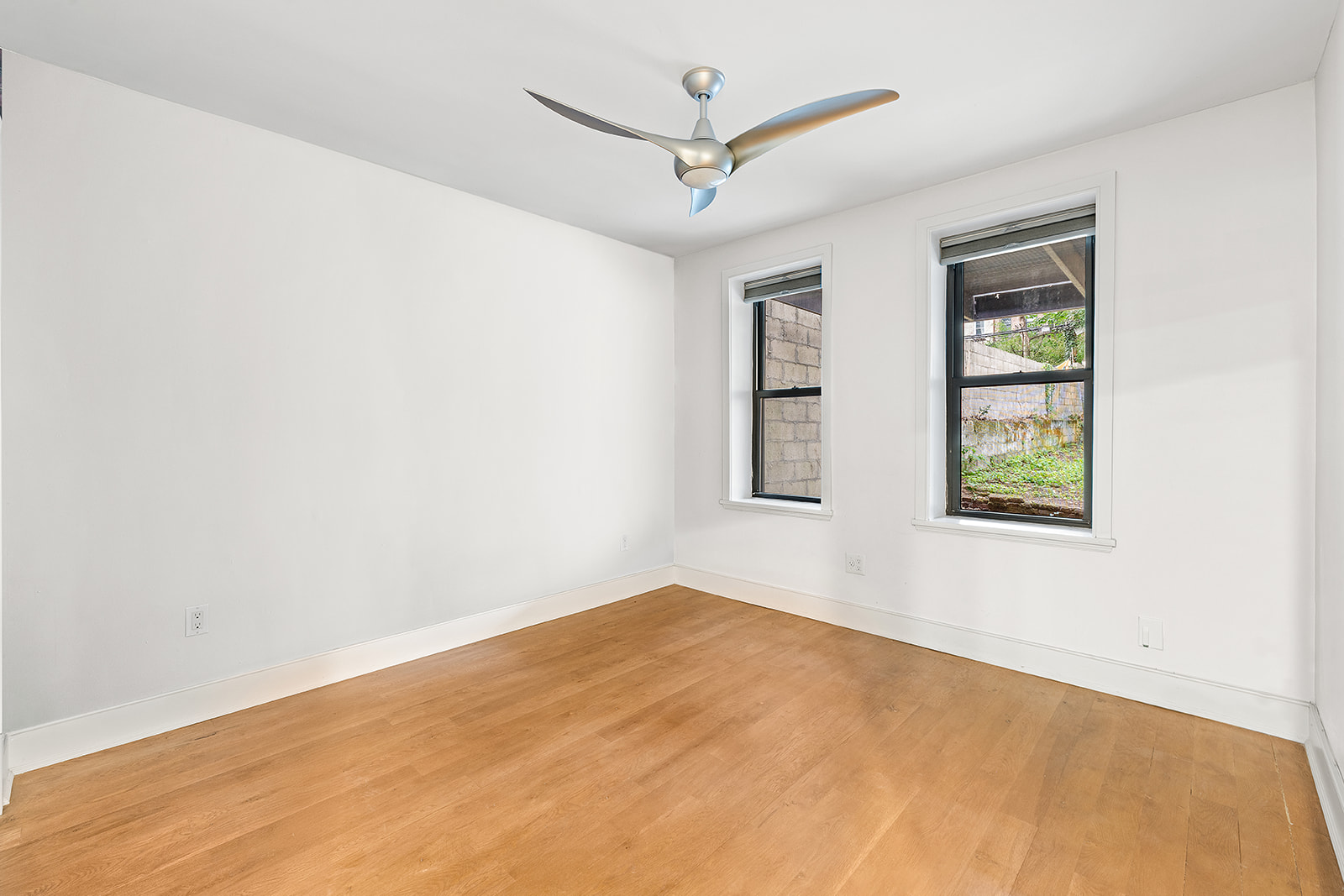 272 Prospect Place, Unit GARDEN Brooklyn, NY 11238 - Photo 6 of 8 an empty room with windows and fan