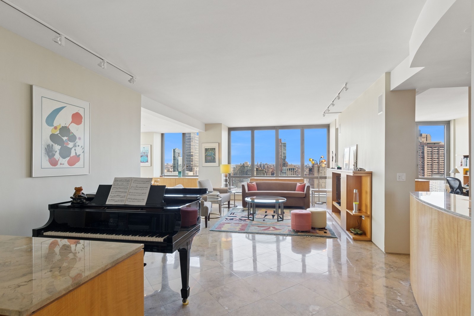 2 Columbus Avenue, Unit 35A Manhattan, NY 10023 - Photo 2 of 13 a living room with furniture a table and kitchen view
