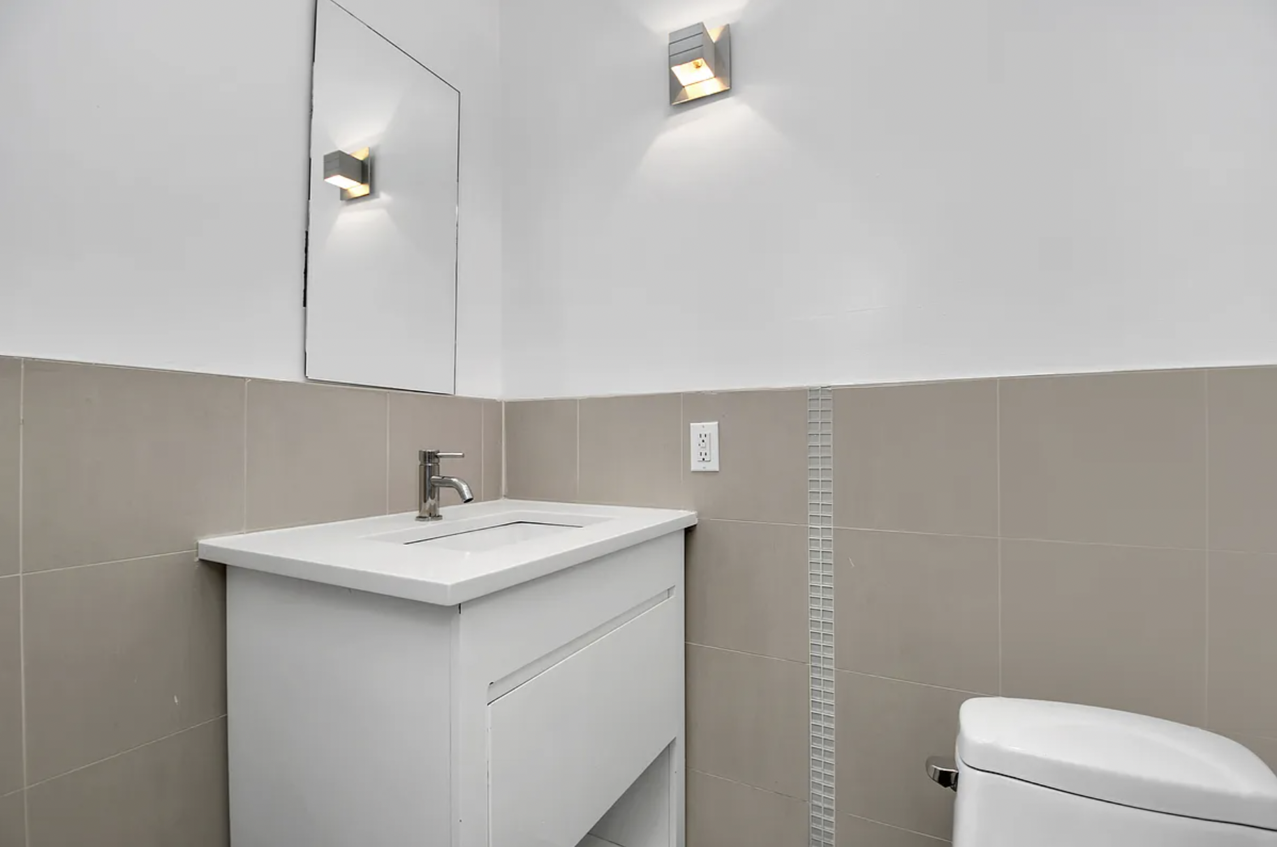 105 Grand Avenue, Unit 1F Brooklyn, NY 11205 - Photo 6 of 7 a bathroom with a sink a toilet and mirror
