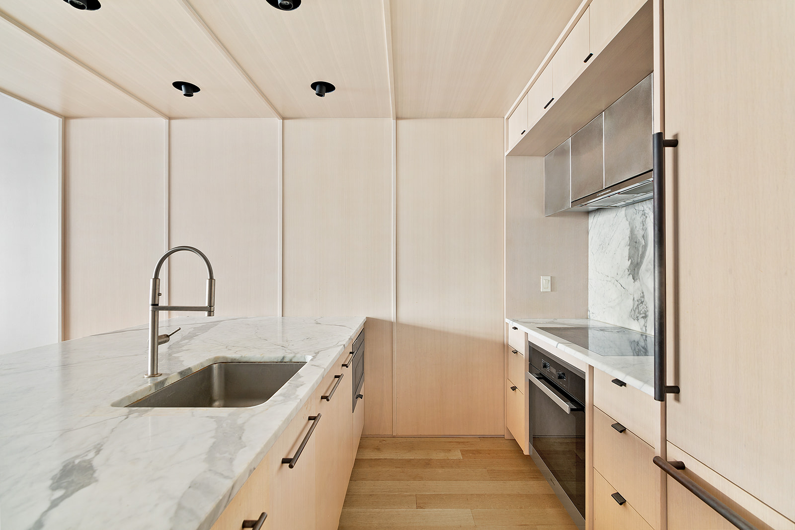 318 West 52nd Street, Unit 3N Manhattan, NY 10019 - Photo 4 of 9 a kitchen with stainless steel appliances granite countertop a sink a stove and a refrigerator