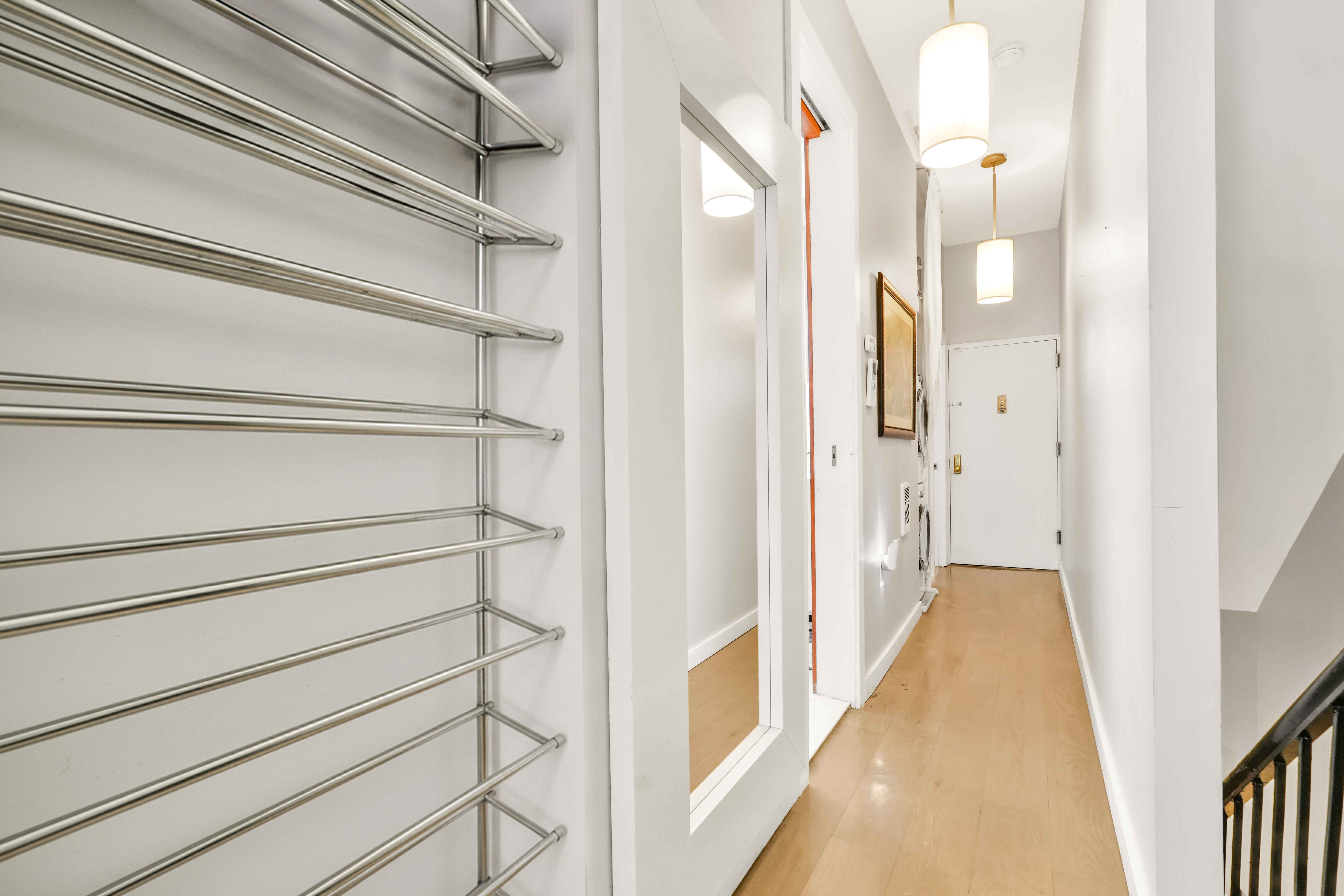 288 St James Place, Unit TRIPLEX Brooklyn, NY 11238 - Photo 12 of 25 a view of a hallway with wooden floor and glass door