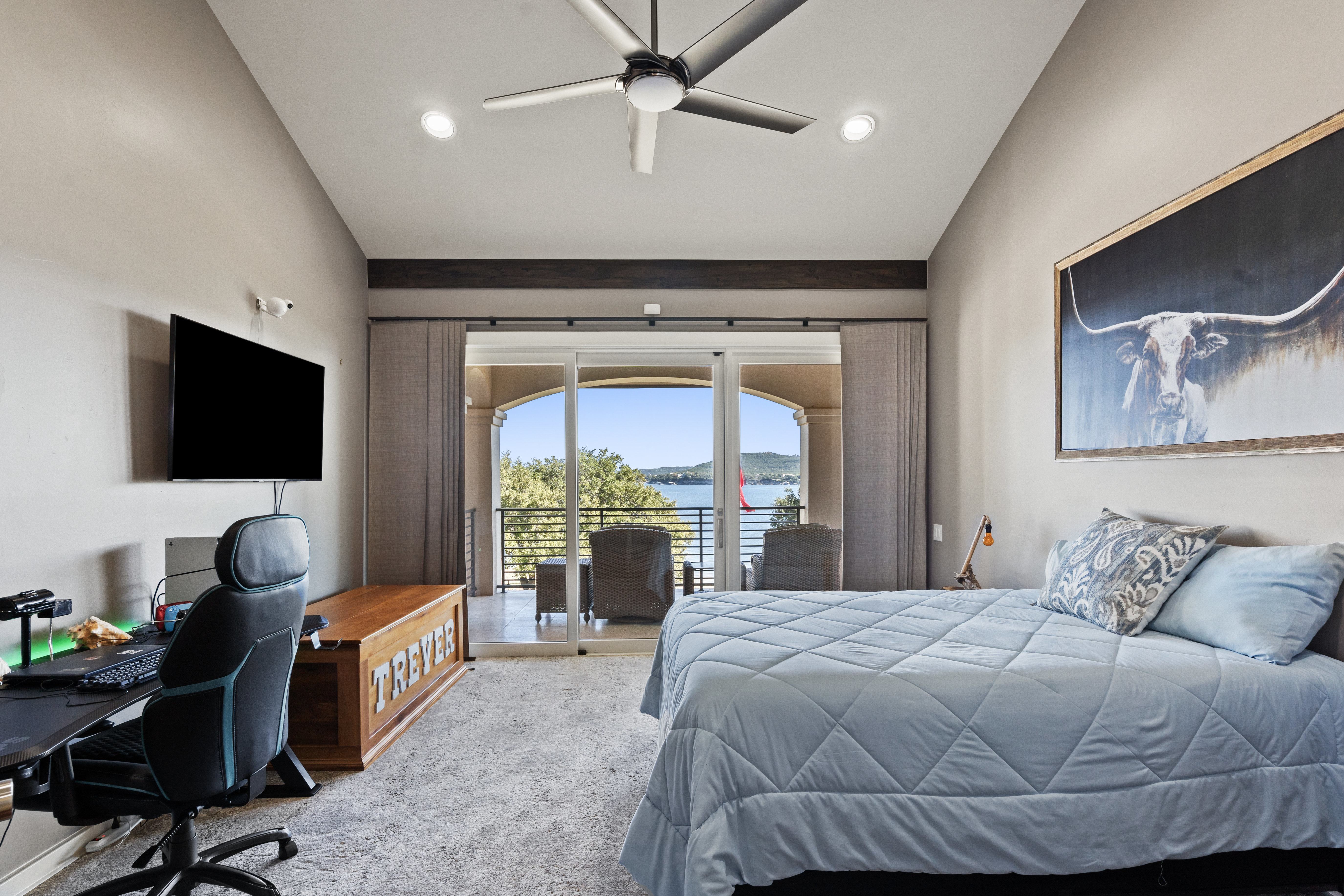 15210 Rainbow 1 Street Austin, TX 78734 - Photo 40 of 138 a bedroom with a bed a large window and a flat screen tv