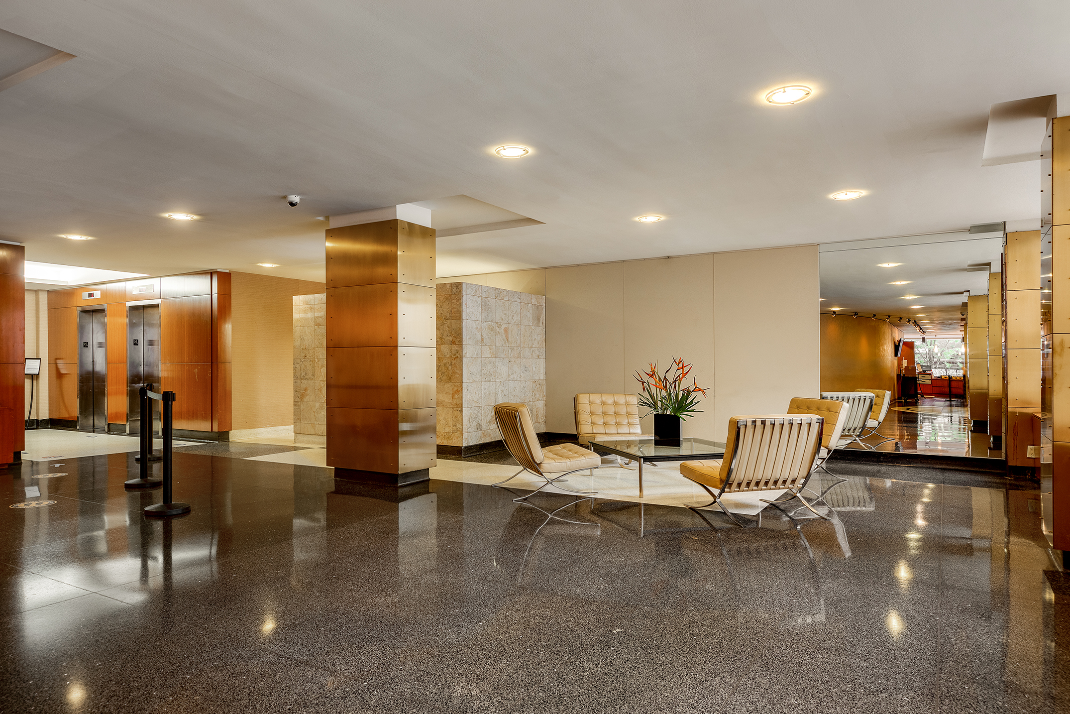 305 East 24th Street, Unit 11G Manhattan, NY 10010 - Photo 8 of 10 a living room with couches and kitchen view with wooden floor