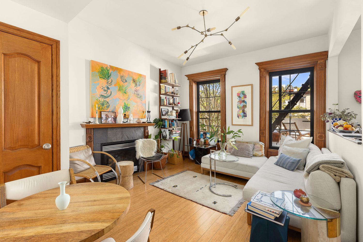 a living room with furniture a large window and a table