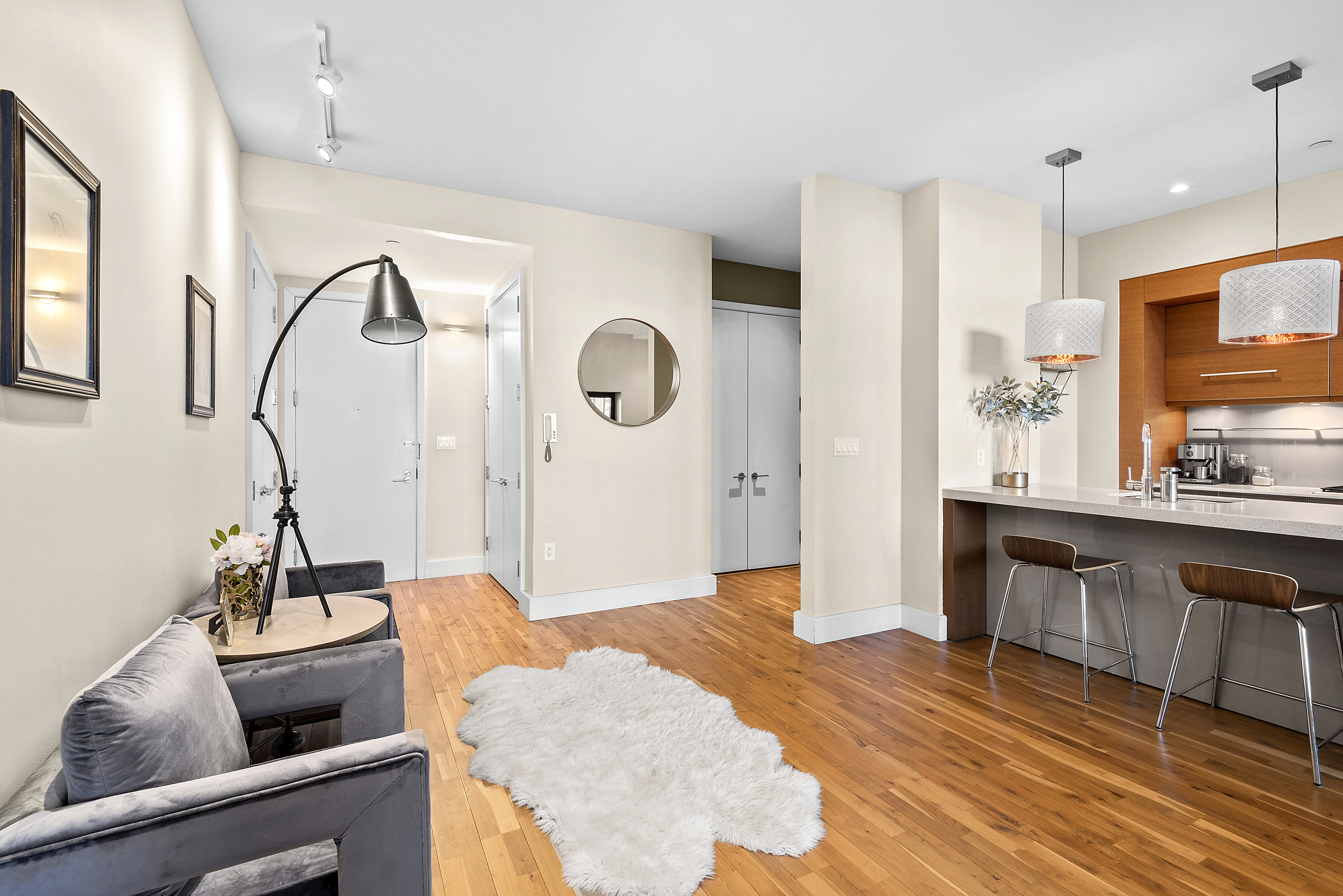 360 Furman Street, Unit 723/724 Brooklyn, NY 11201 - Photo 19 of 63 a living room with granite countertop furniture a sink a rug and wooden floor