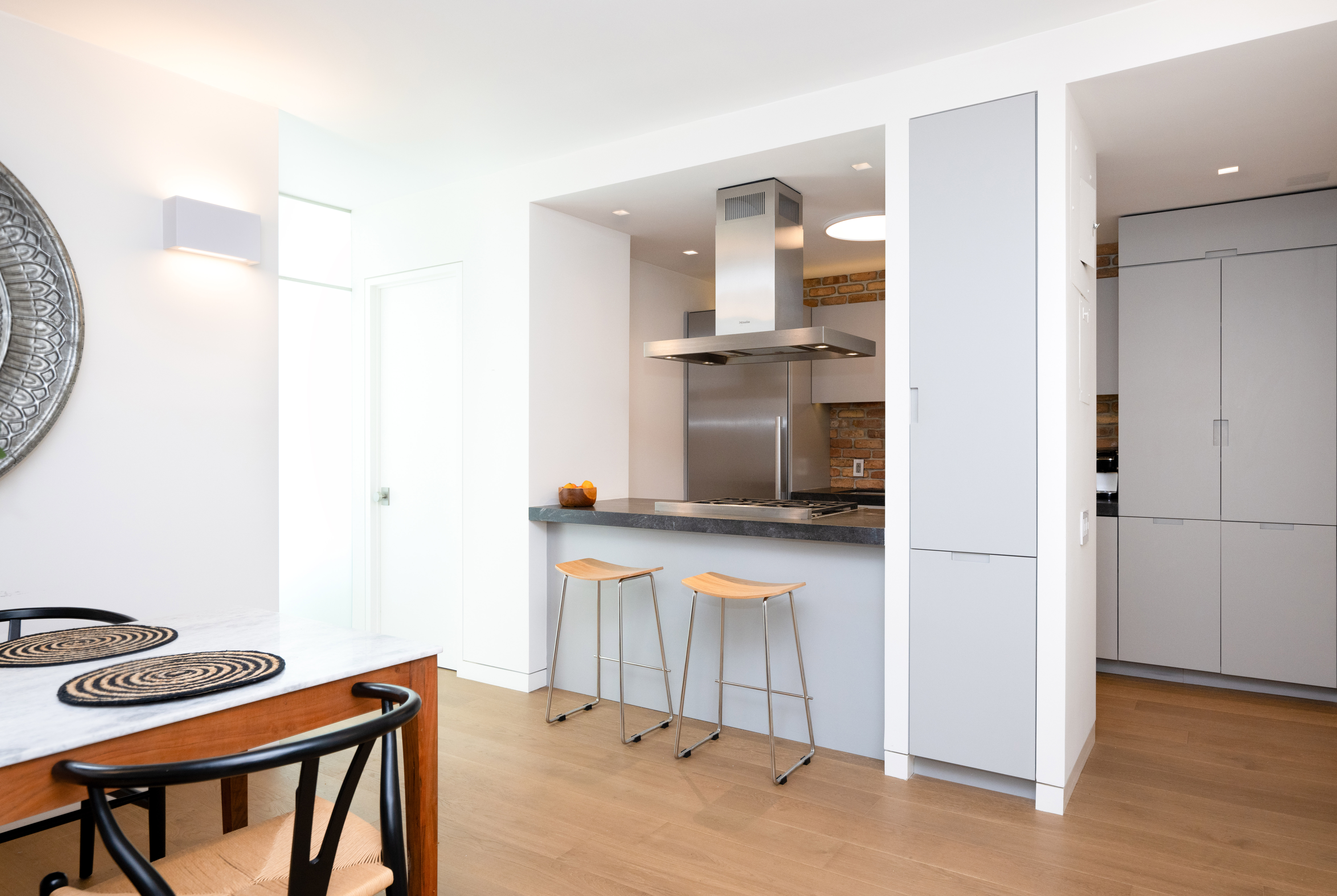 124 East 79th Street, Unit 7D Manhattan, NY 10075 - Photo 14 of 25 a kitchen with a refrigerator and a stove top oven
