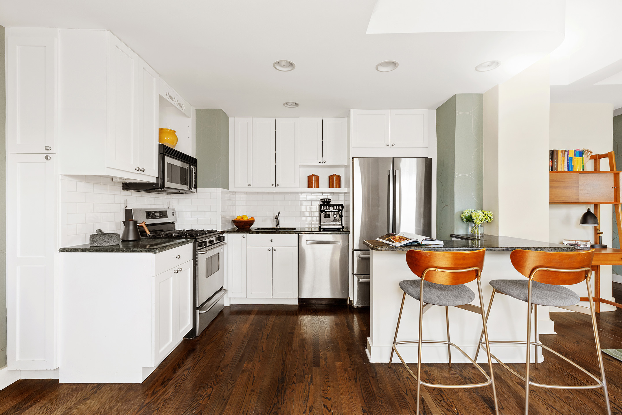 2166 Broadway, Unit 17C Manhattan, NY 10024 - Photo 4 of 11 a kitchen with stainless steel appliances kitchen island granite countertop a refrigerator and a stove top oven