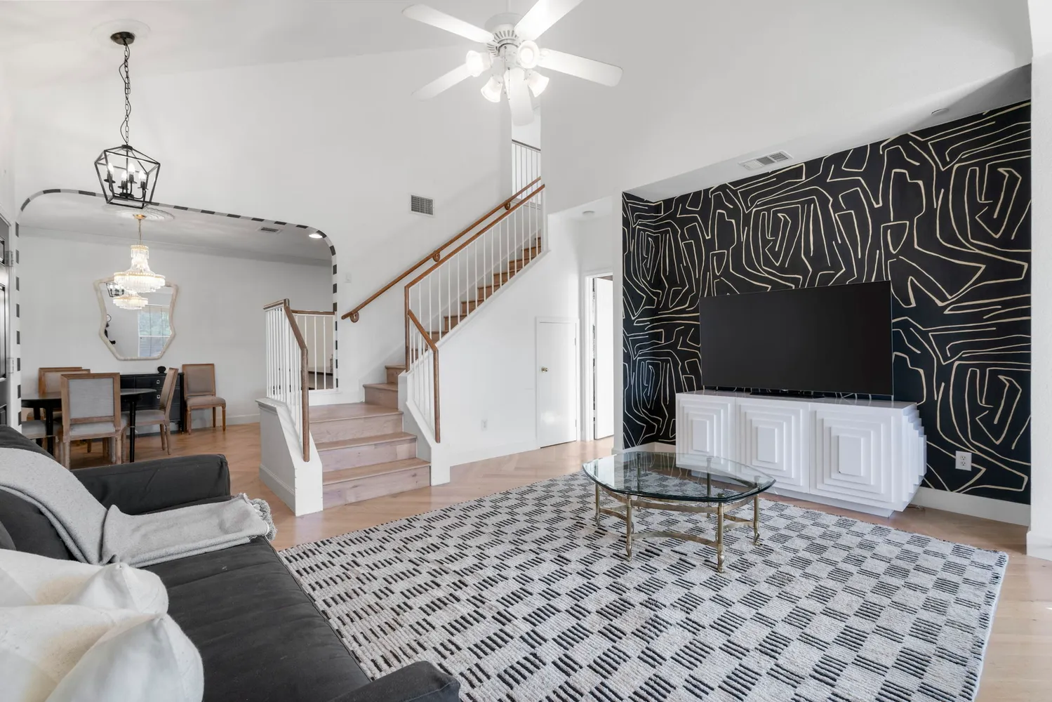 a living room with furniture and wooden floor