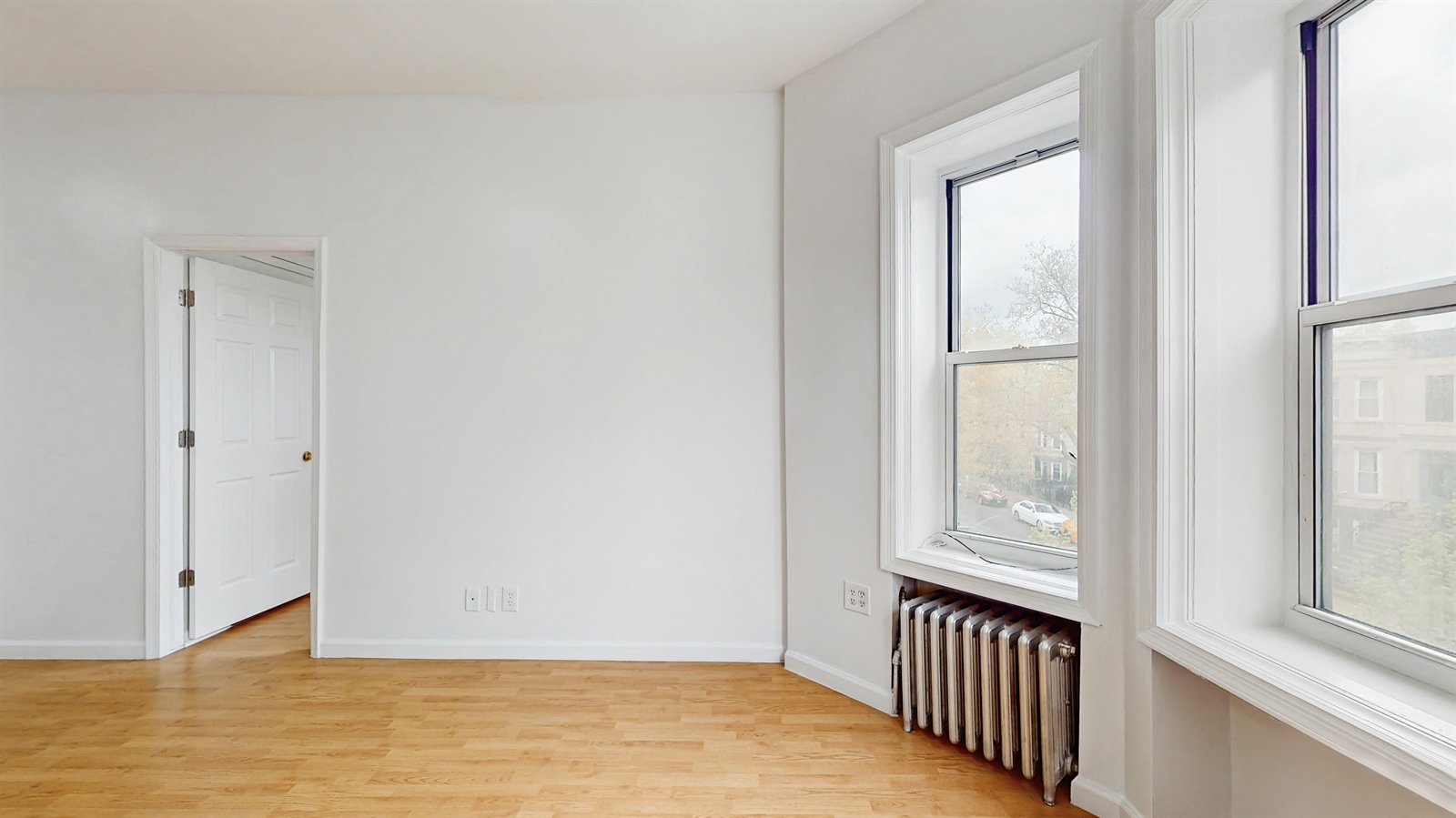 454 77th Street, Unit 3 Brooklyn, NY 11209 - Photo 21 of 25 a view of an empty room with wooden floor and a window