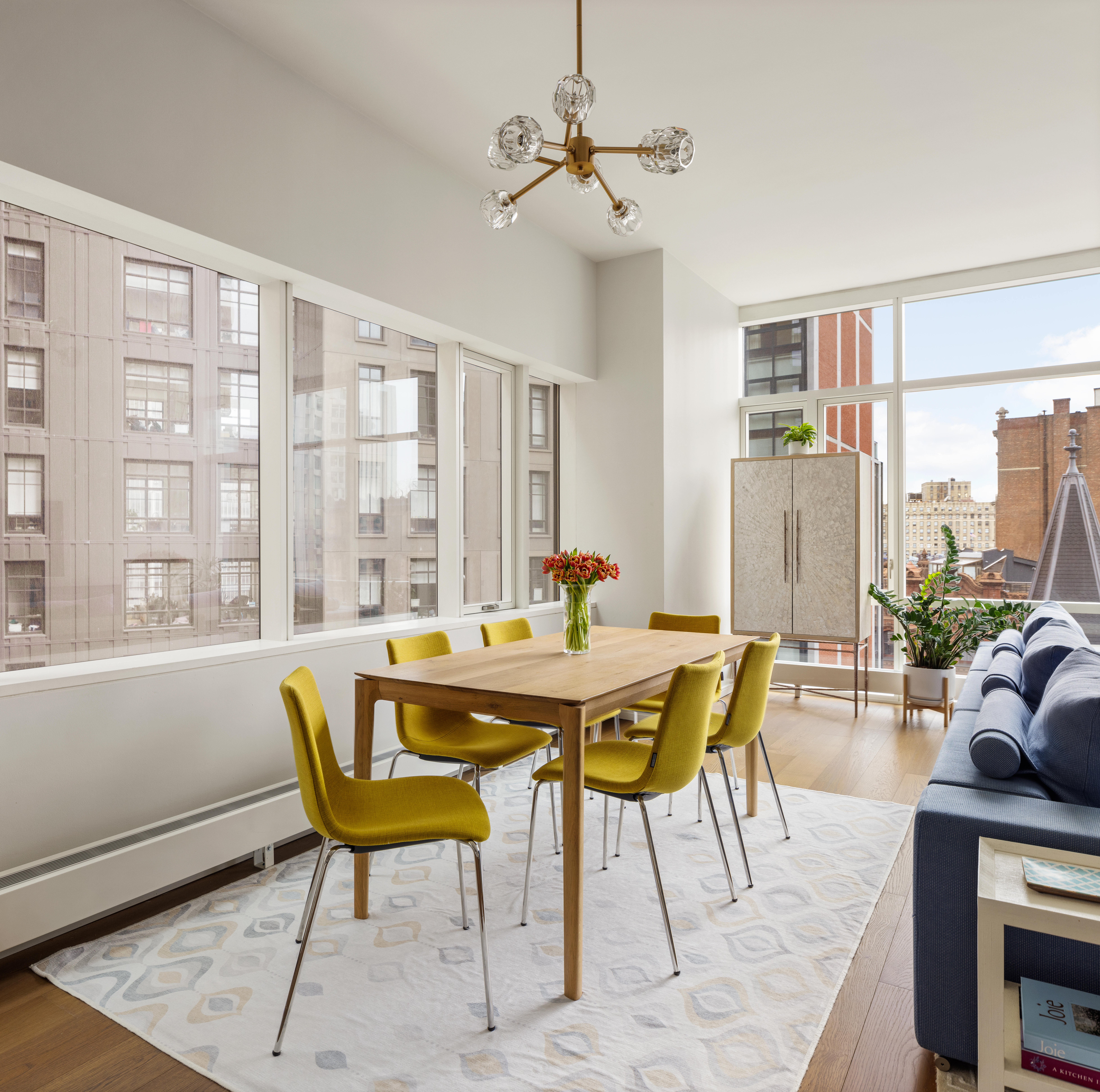 121 Nassau Street, Unit 17A Manhattan, NY 10038 - Photo 5 of 19 a view of a dining room with furniture window and outside view