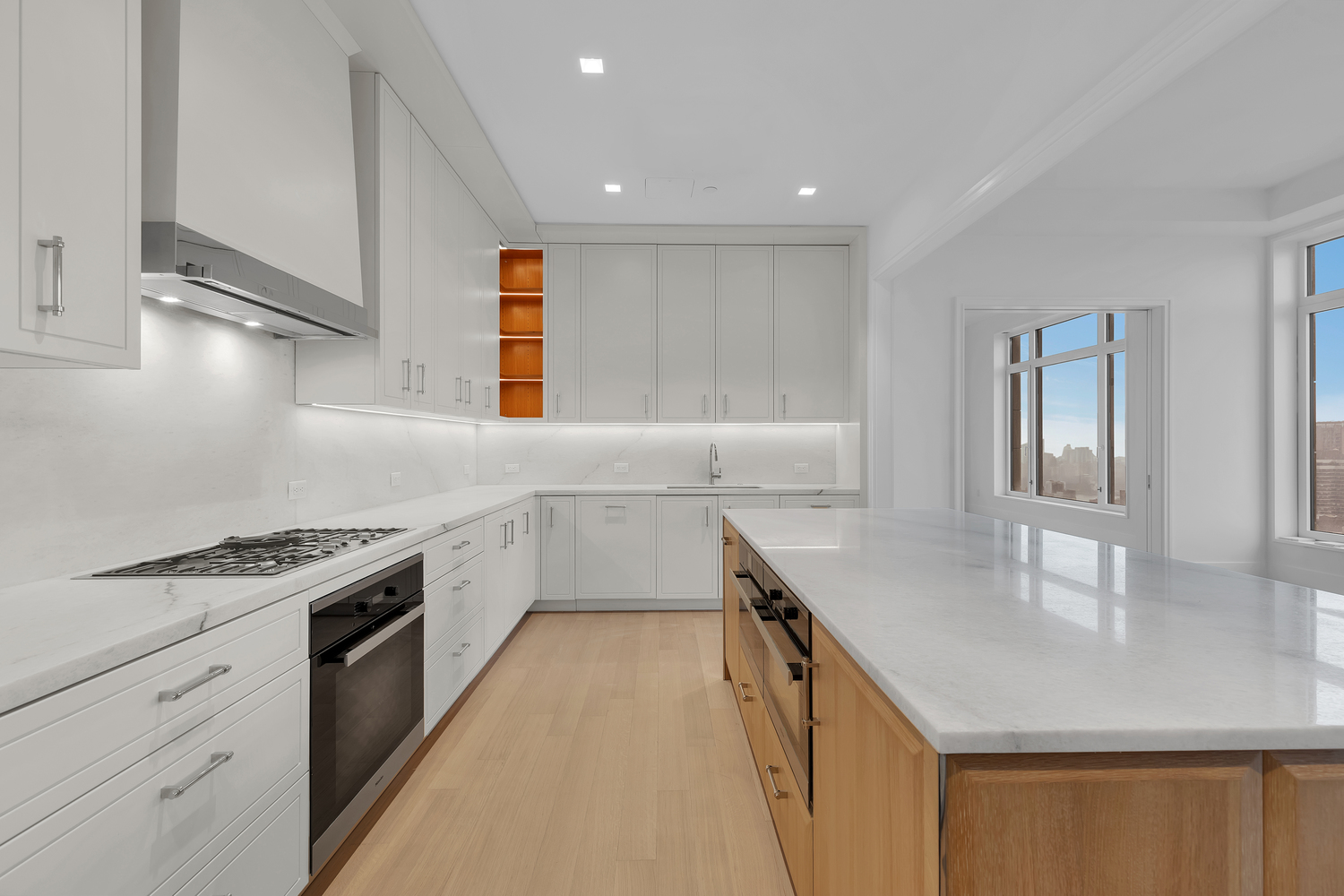 200 East 83rd Street, Unit 34A Manhattan, NY 10028 - Photo 10 of 34 a kitchen with a sink stove and cabinets