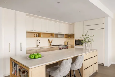 a kitchen with a sink a stove and cabinets