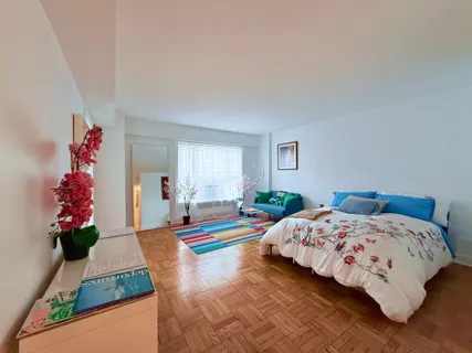 a bedroom with bed and window