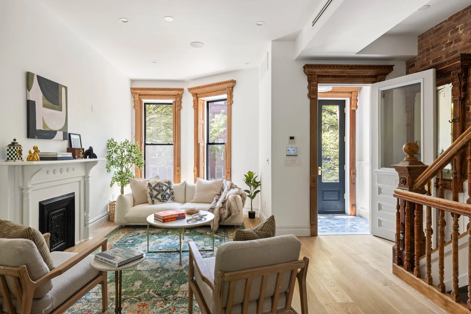 a living room with furniture fireplace and a large window