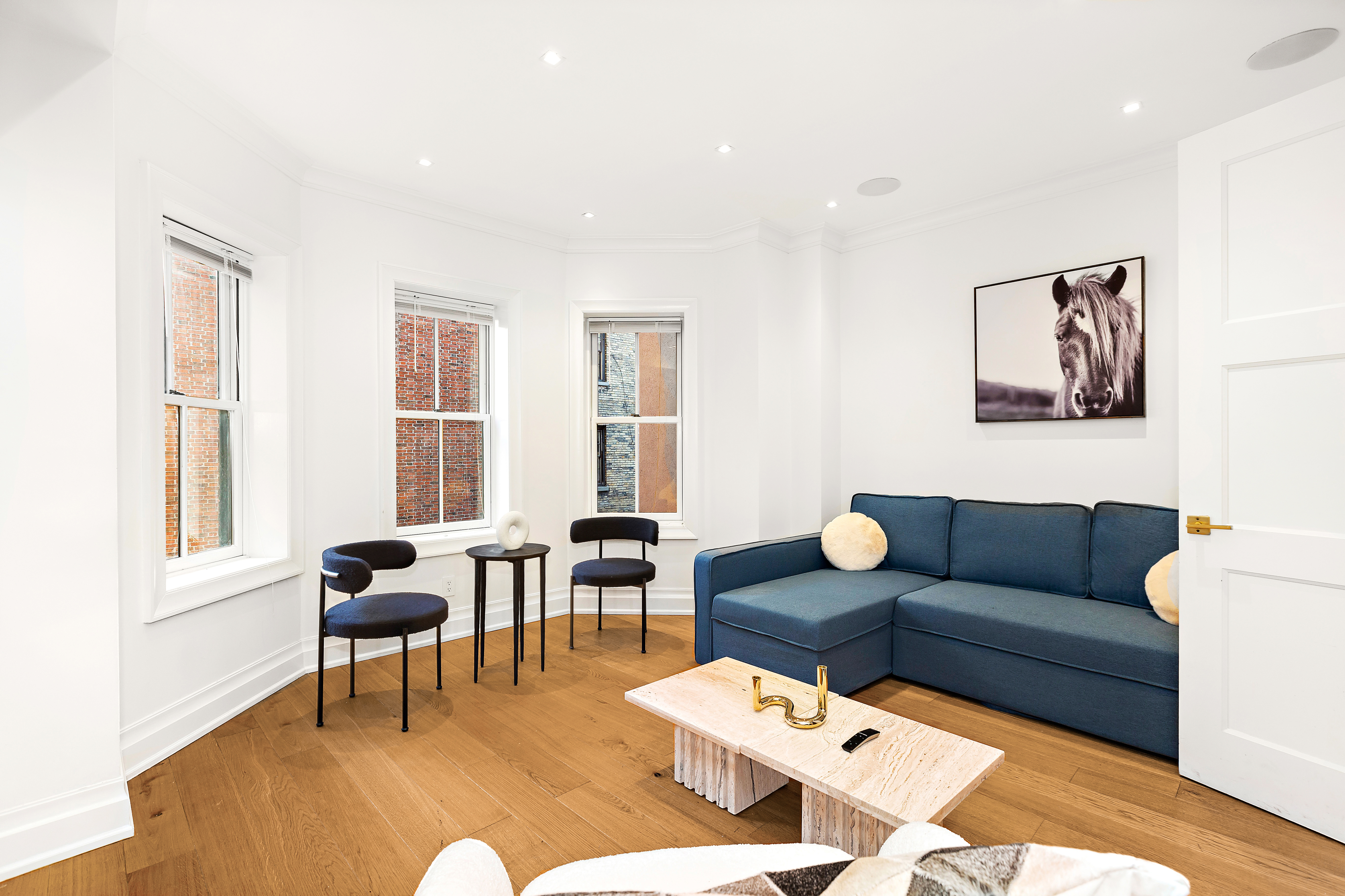134 East 36th Street Manhattan, NY 10016 - Photo 17 of 28 a living room with furniture and a window