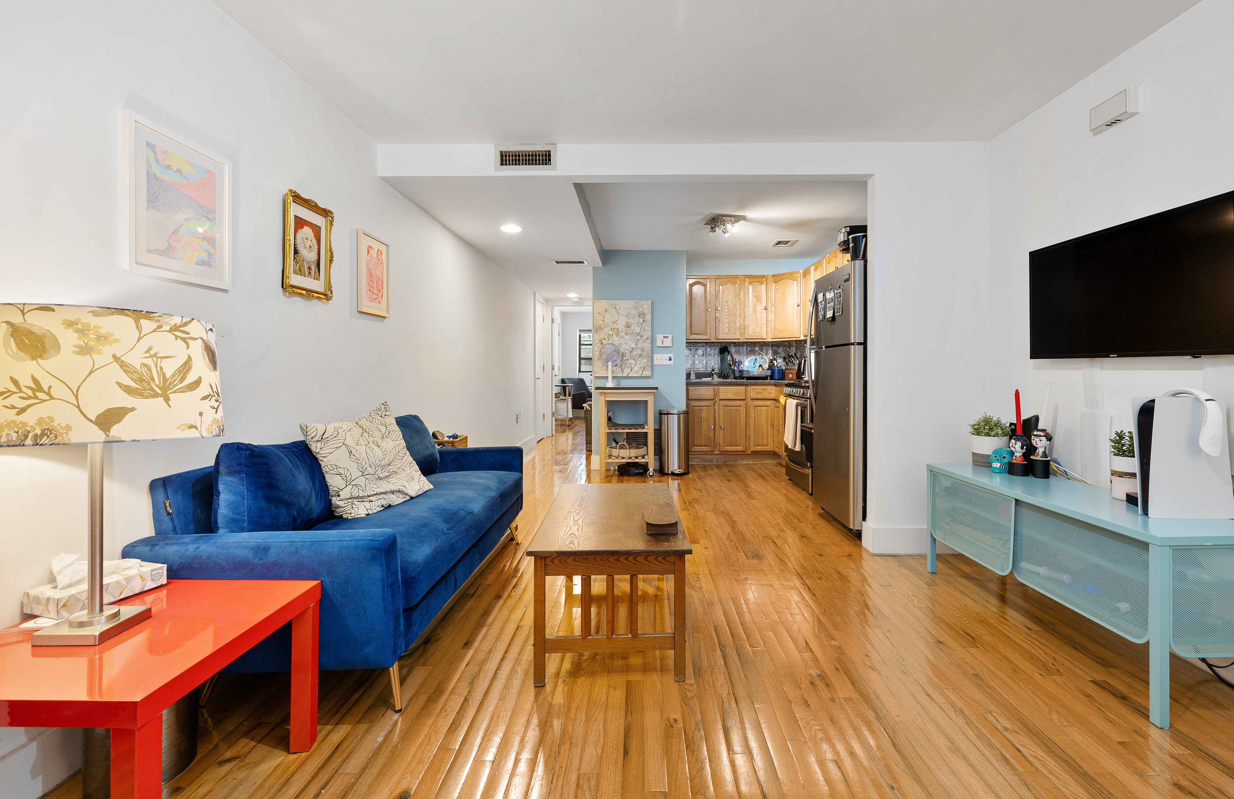 160 West 128th Street, Unit 1 Manhattan, NY 10027 - Photo 1 of 5 a living room with furniture and a flat screen tv