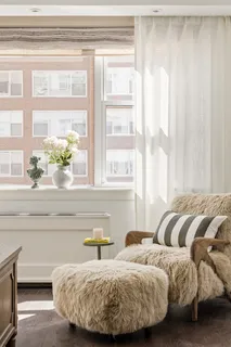 a bedroom with two beds and a window with outer view