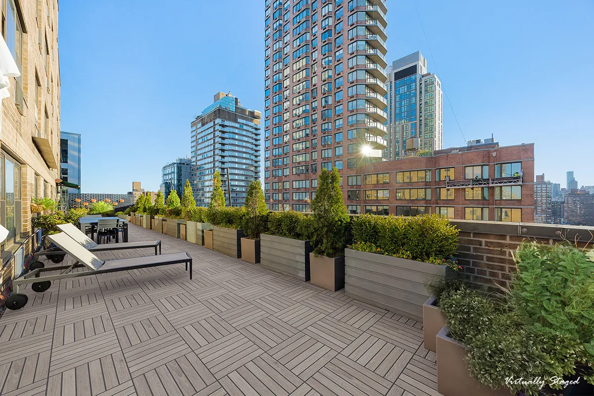a view of a balcony with chairs and a potted plant