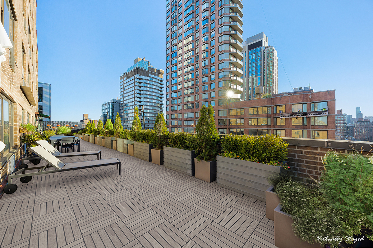 333 East 79th Street, Unit 18N Manhattan, NY 10075 - Photo 2 of 11 a view of a balcony with chairs and a potted plant