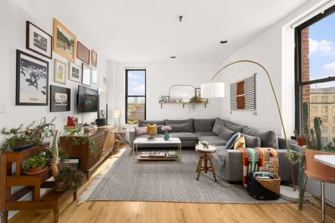 a living room with furniture or couch and a large window