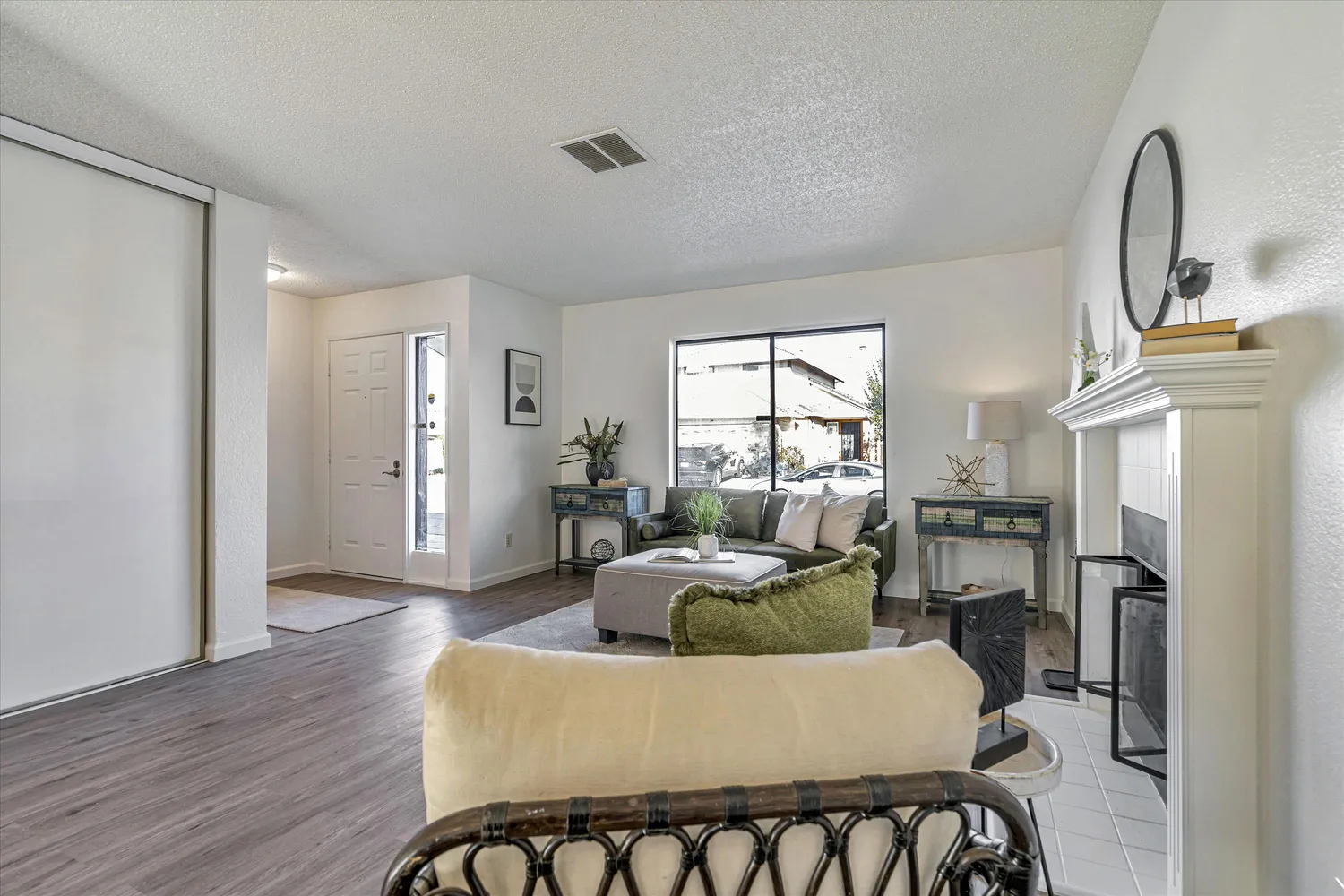 a living room with furniture and wooden floor