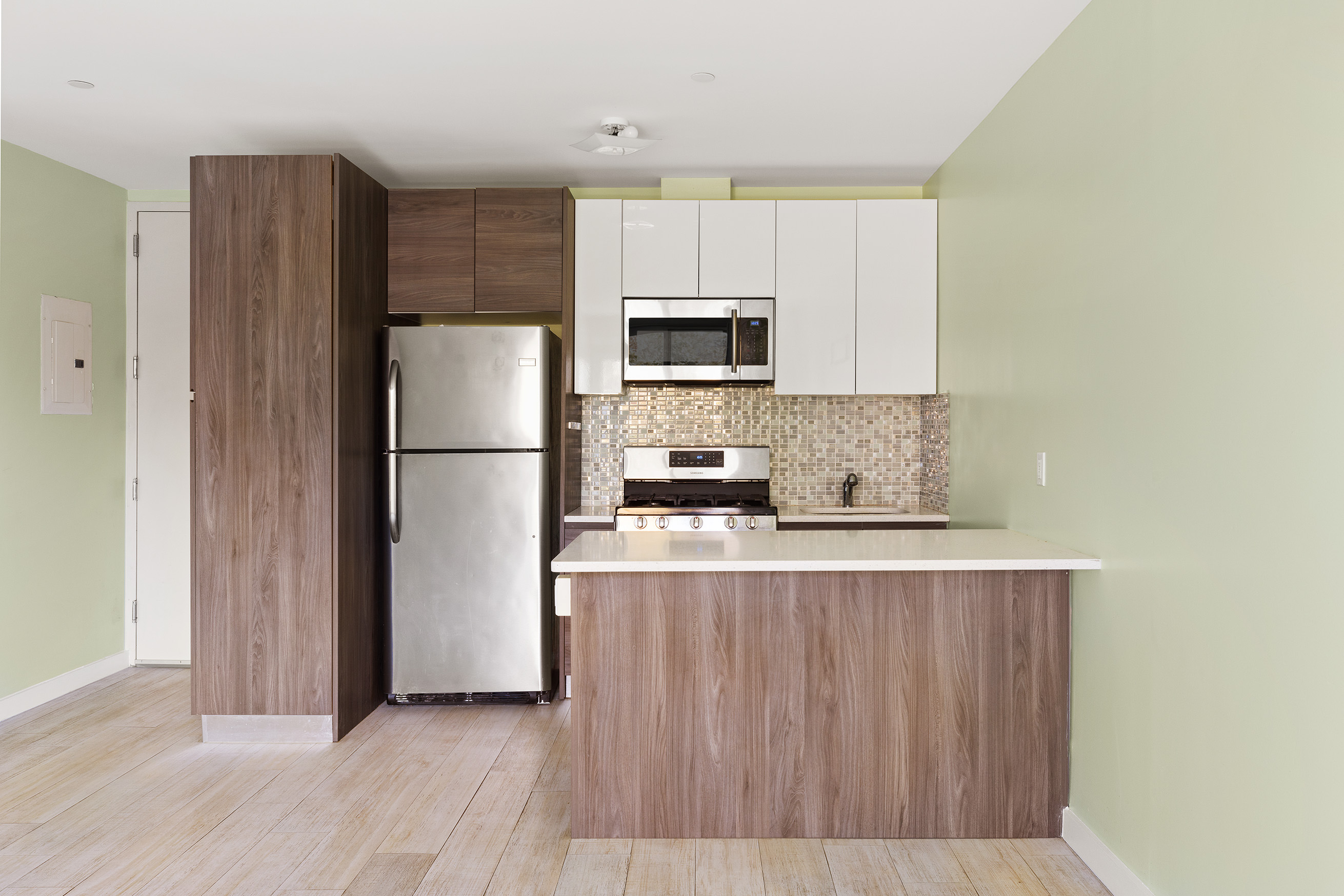 1972 Ocean Avenue, Unit 4A Brooklyn, NY 11230 - Photo 6 of 18 a kitchen with stainless steel appliances a refrigerator and a stove top oven
