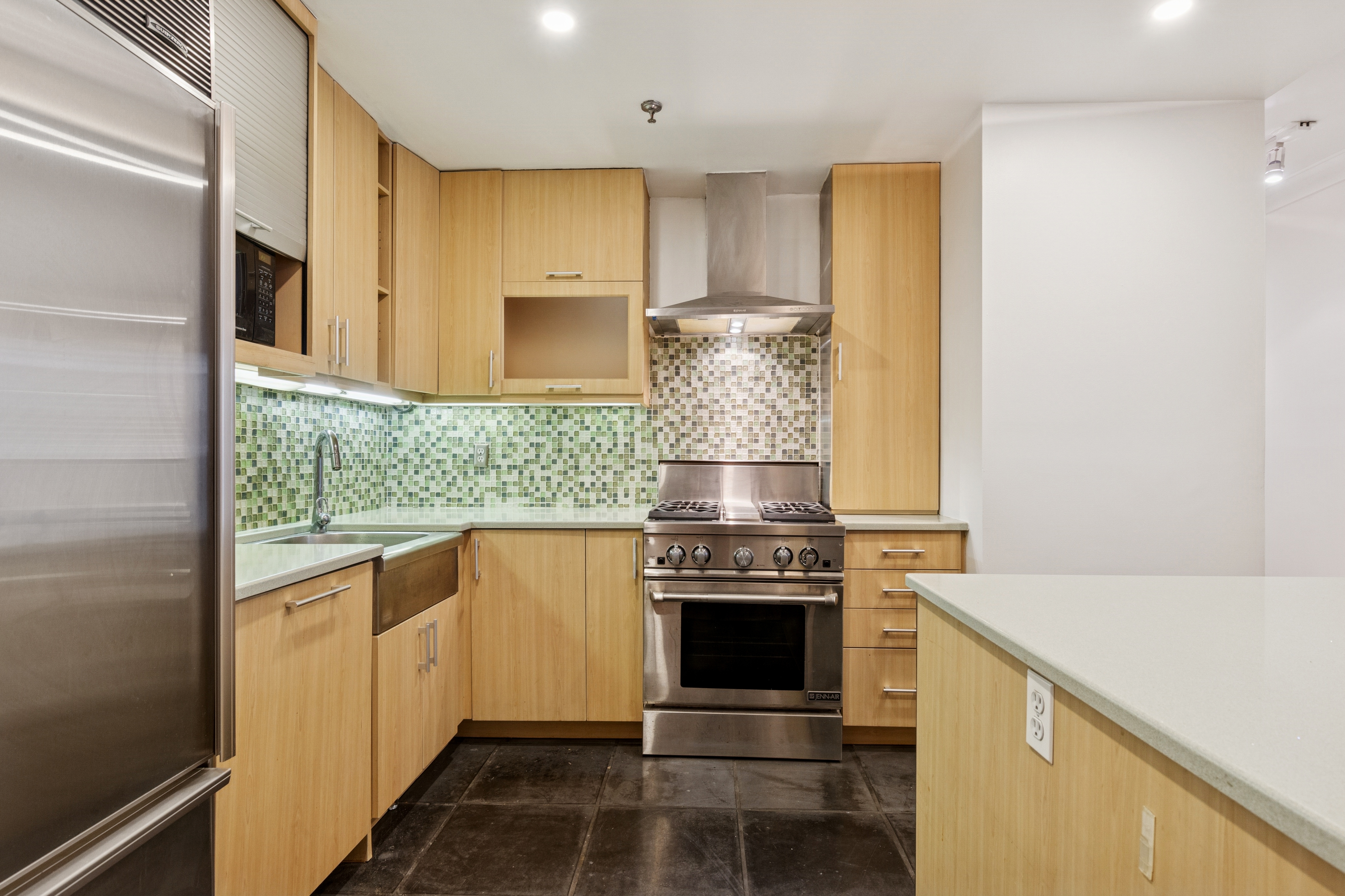 136-140 West 23rd Street, Unit 4CC Manhattan, NY 10011 - Photo 6 of 14 a kitchen with a stove and a sink