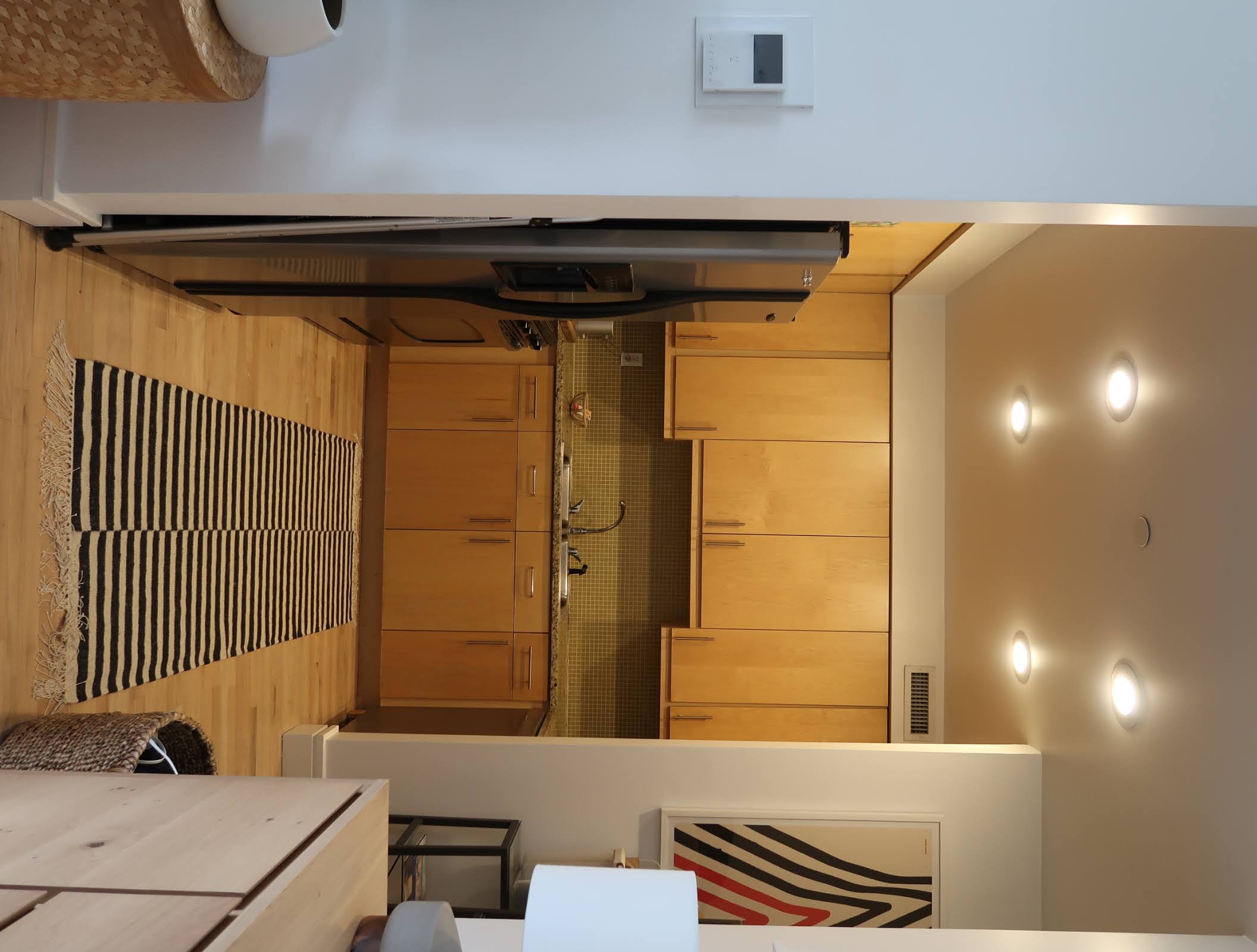 296 East 2nd Street, Unit 4G Manhattan, NY 10009 - Photo 10 of 14 a kitchen with stainless steel appliances a refrigerator sink and white cabinets