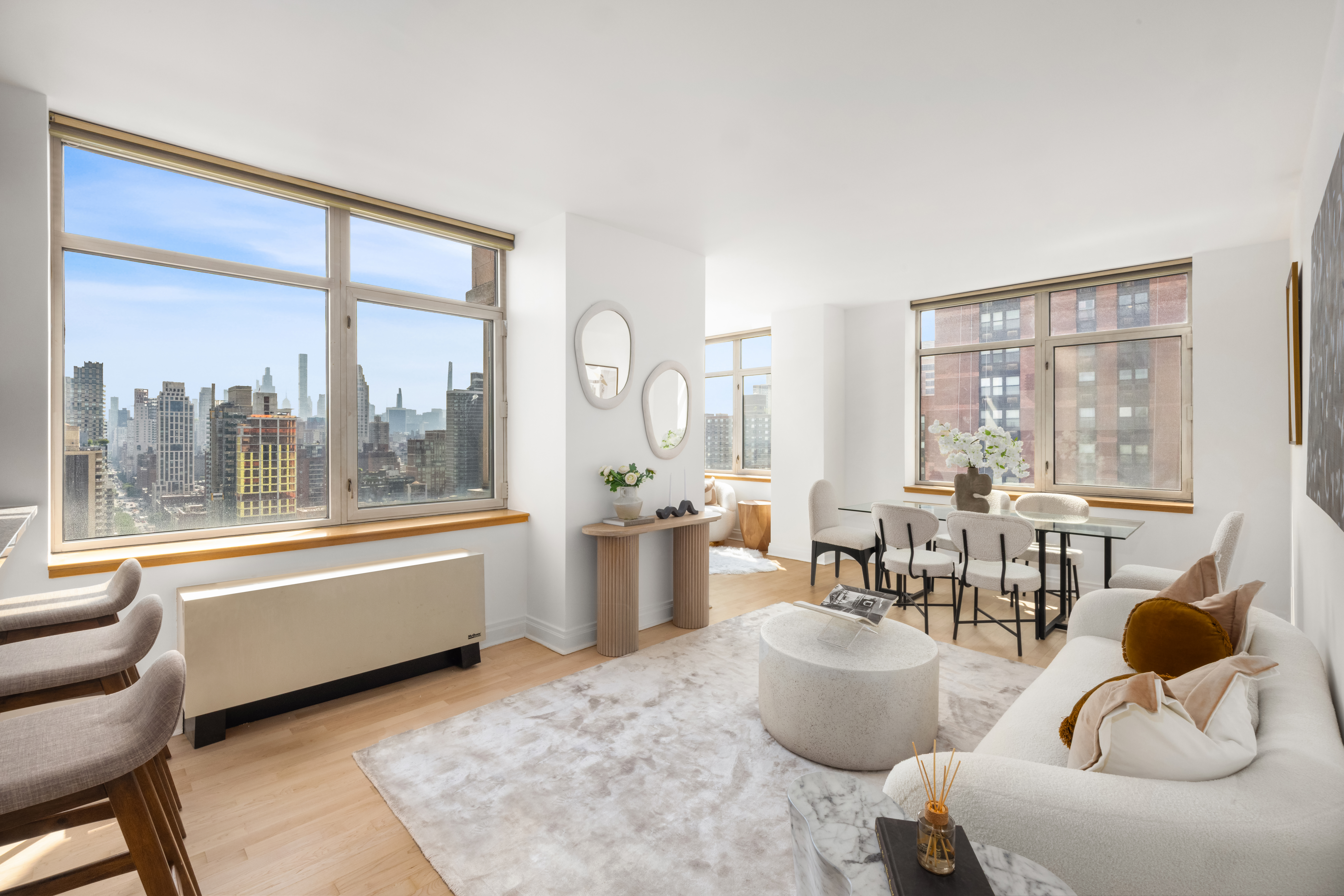 1760 2nd Avenue, Unit 30C Manhattan, NY 10128 - Photo 2 of 21 a living room with furniture and floor to ceiling windows