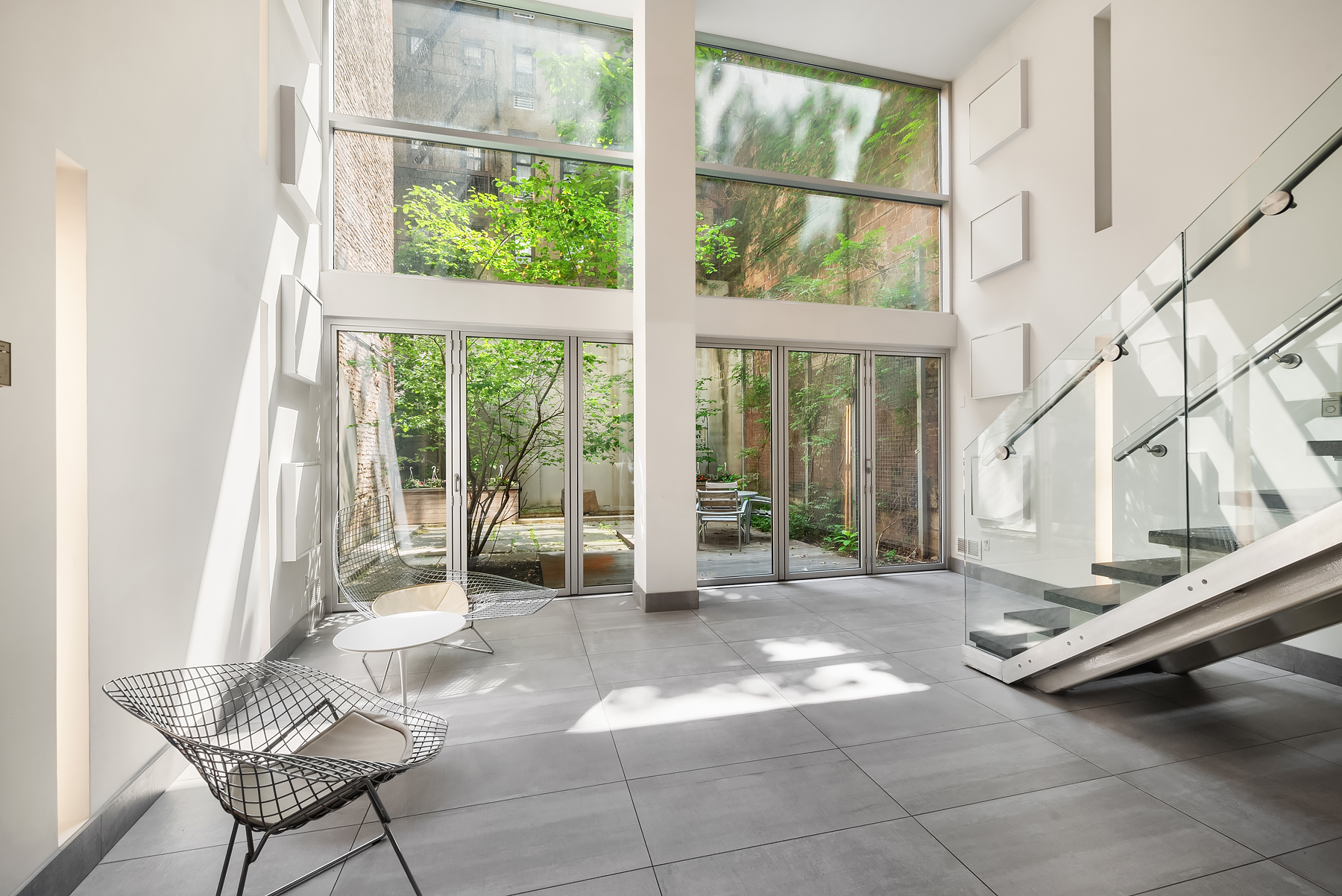 420 West 25th Street, Unit 2K Manhattan, NY 10001 - Photo 13 of 18 a living room with a large window and furniture