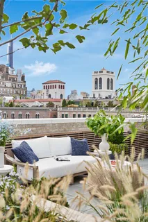 a view of a patio with couches and potted plants