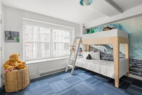 a bedroom with furniture and a window