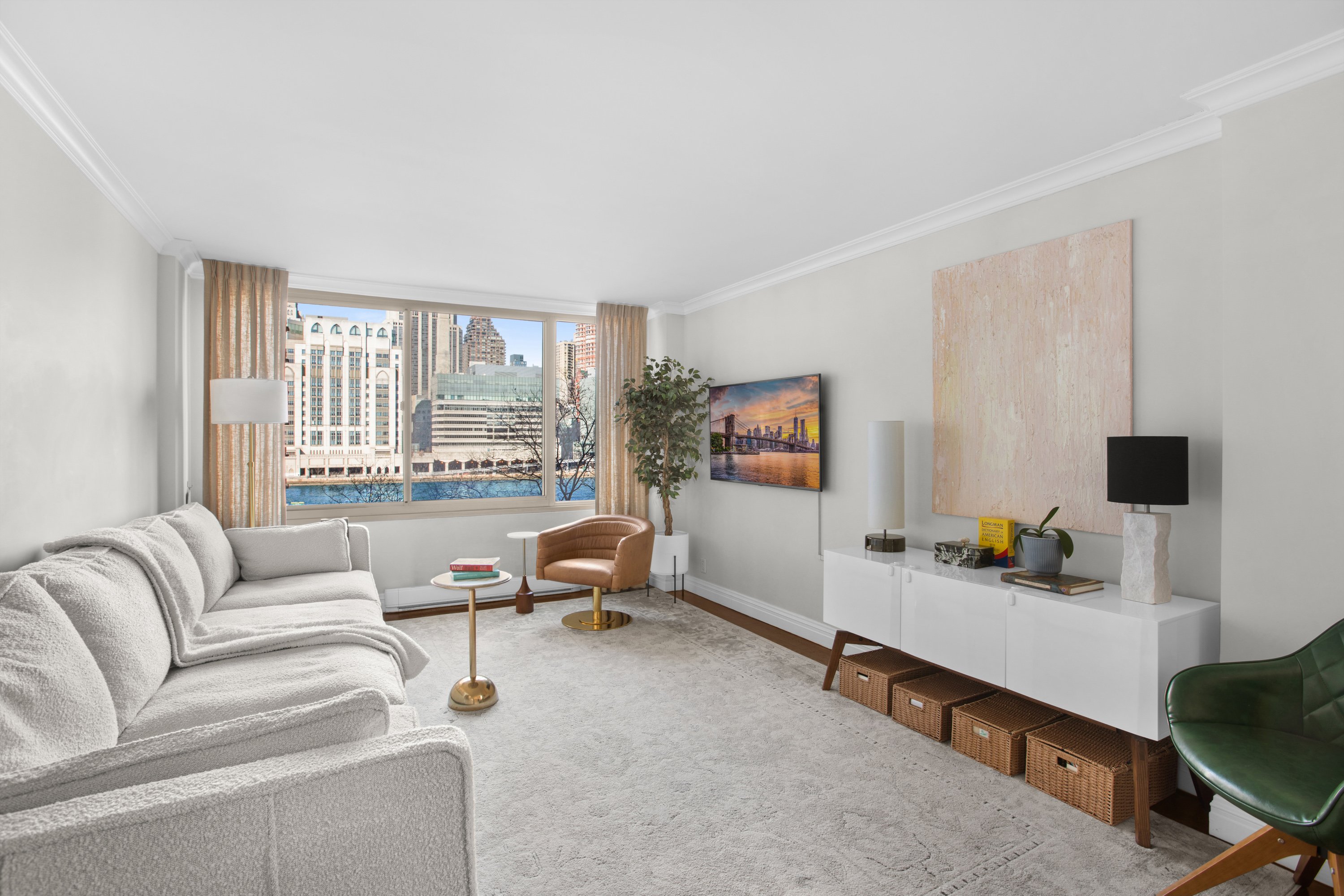 575 Main Street, Unit 509 Manhattan, NY 10044 - Photo 2 of 25 a living room with furniture and a flat screen tv