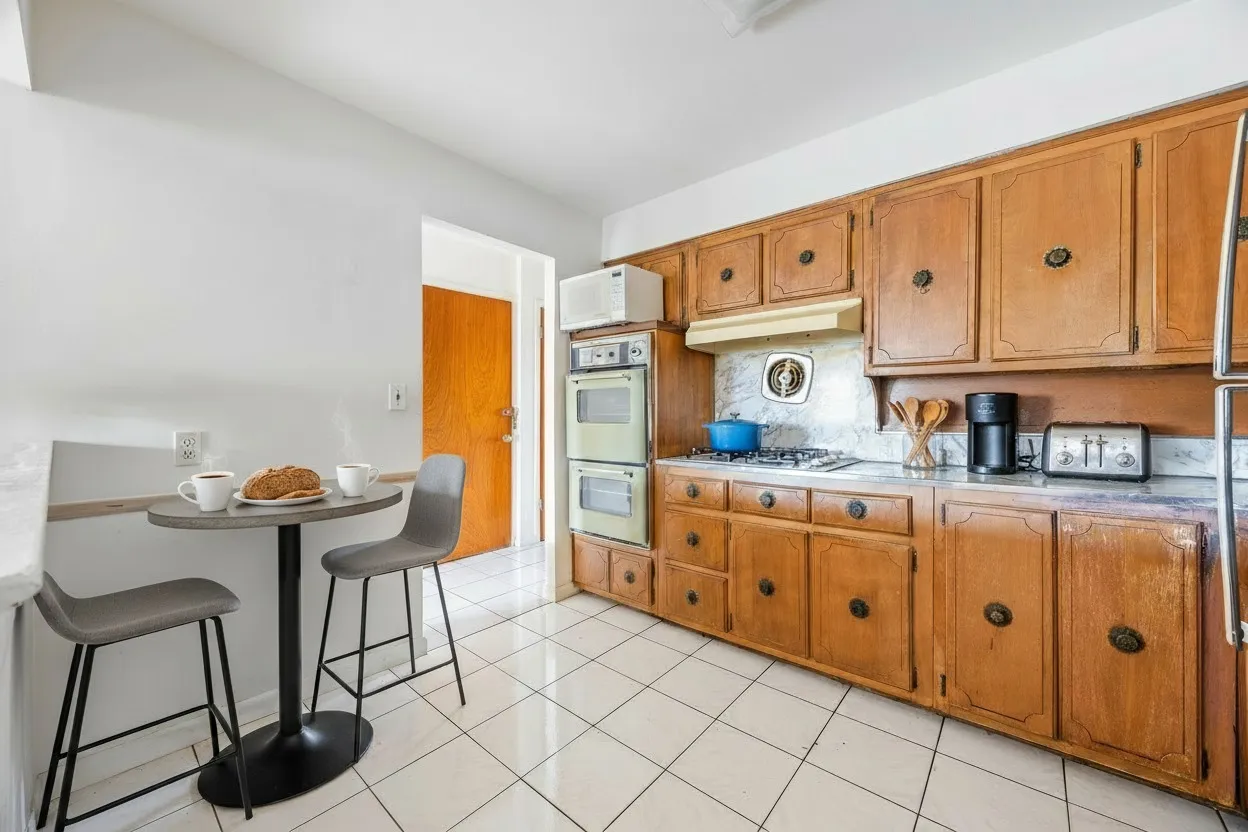 a kitchen with granite countertop a sink cabinets and stove top oven