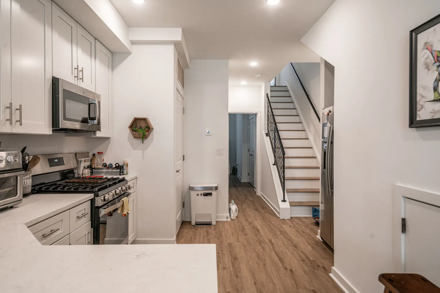 a kitchen with a sink a refrigerator and a stove top oven